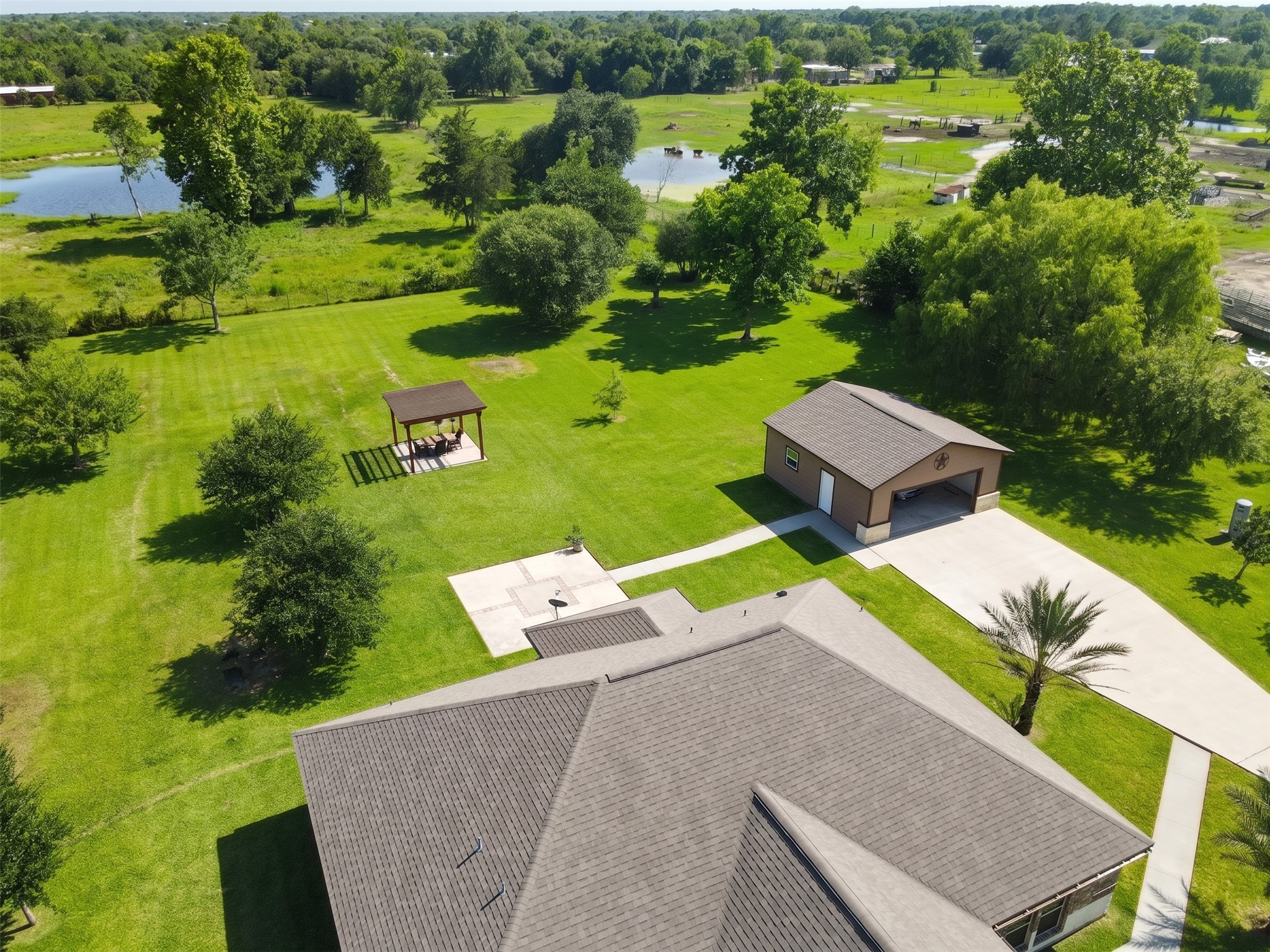 Discover your dream home from above, showcasing an impeccable roofline and expansive green surroundings, perfect for serene living.