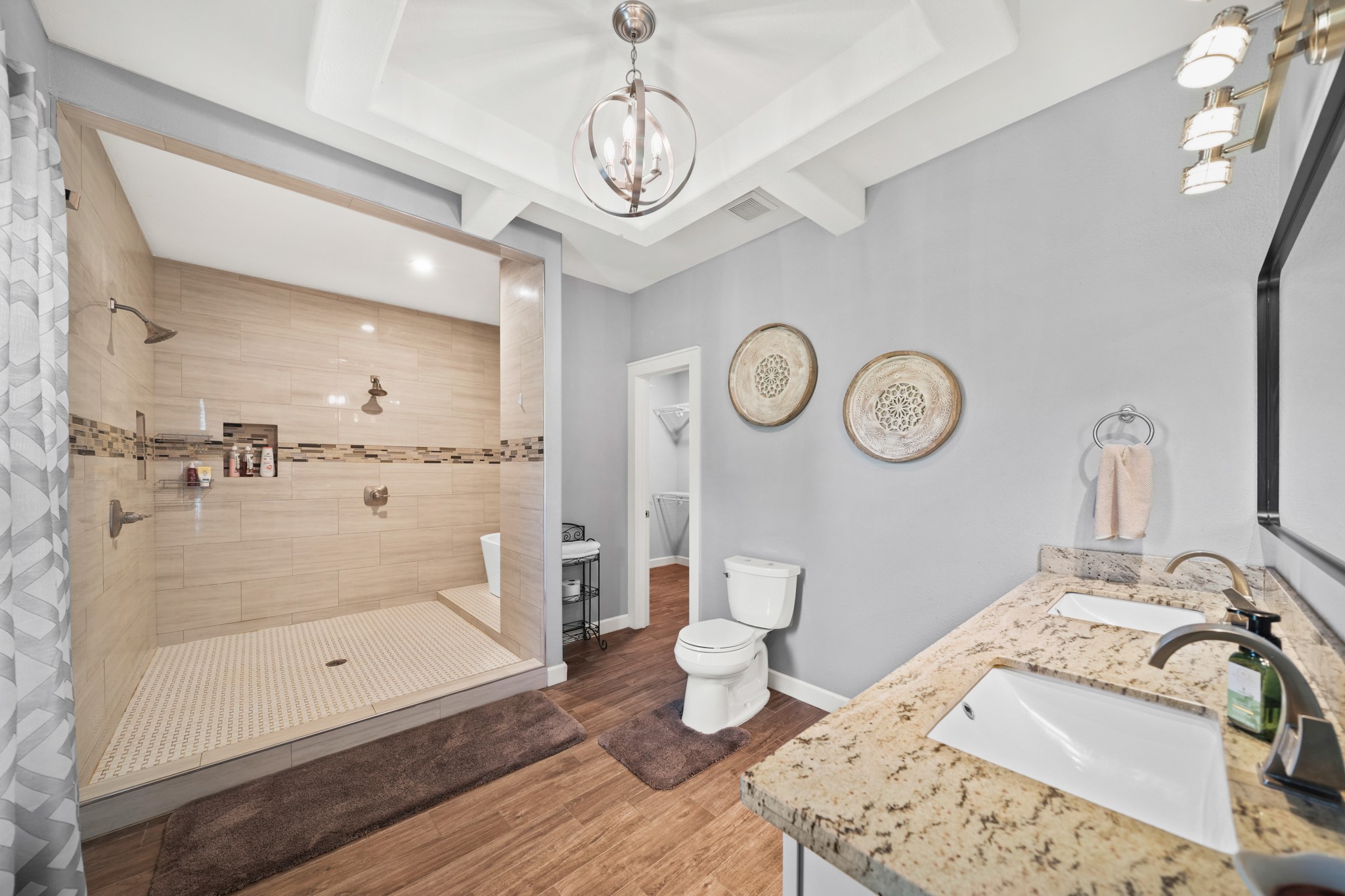 Primary Bathroom: Wide shot capturing the double vanity and the entrance to the massive walk-in shower