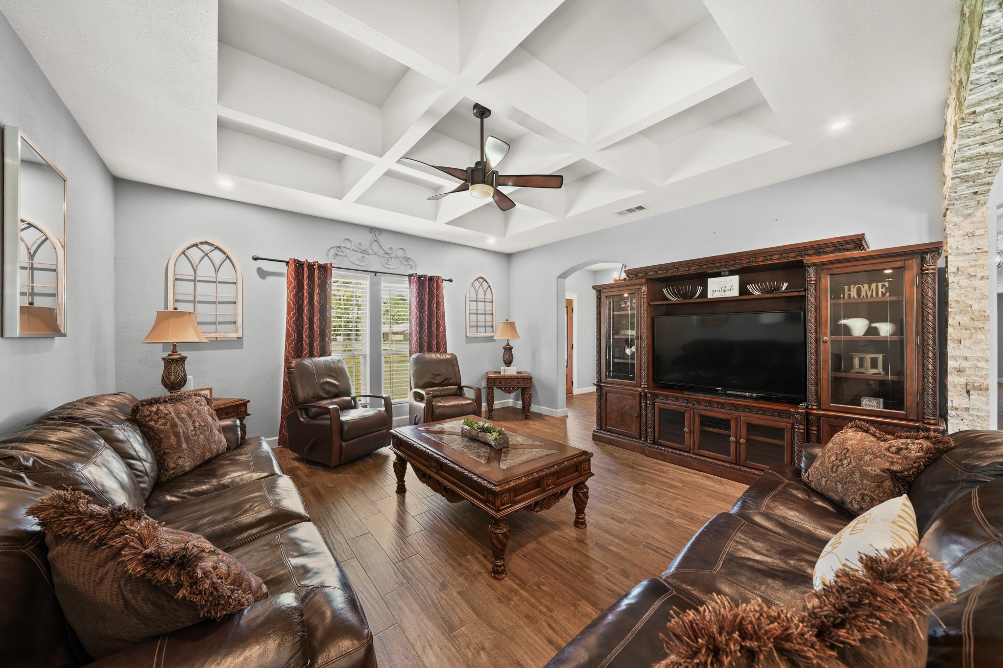 Living Room Detail: Highlights the coffered ceiling and massive entertainment center