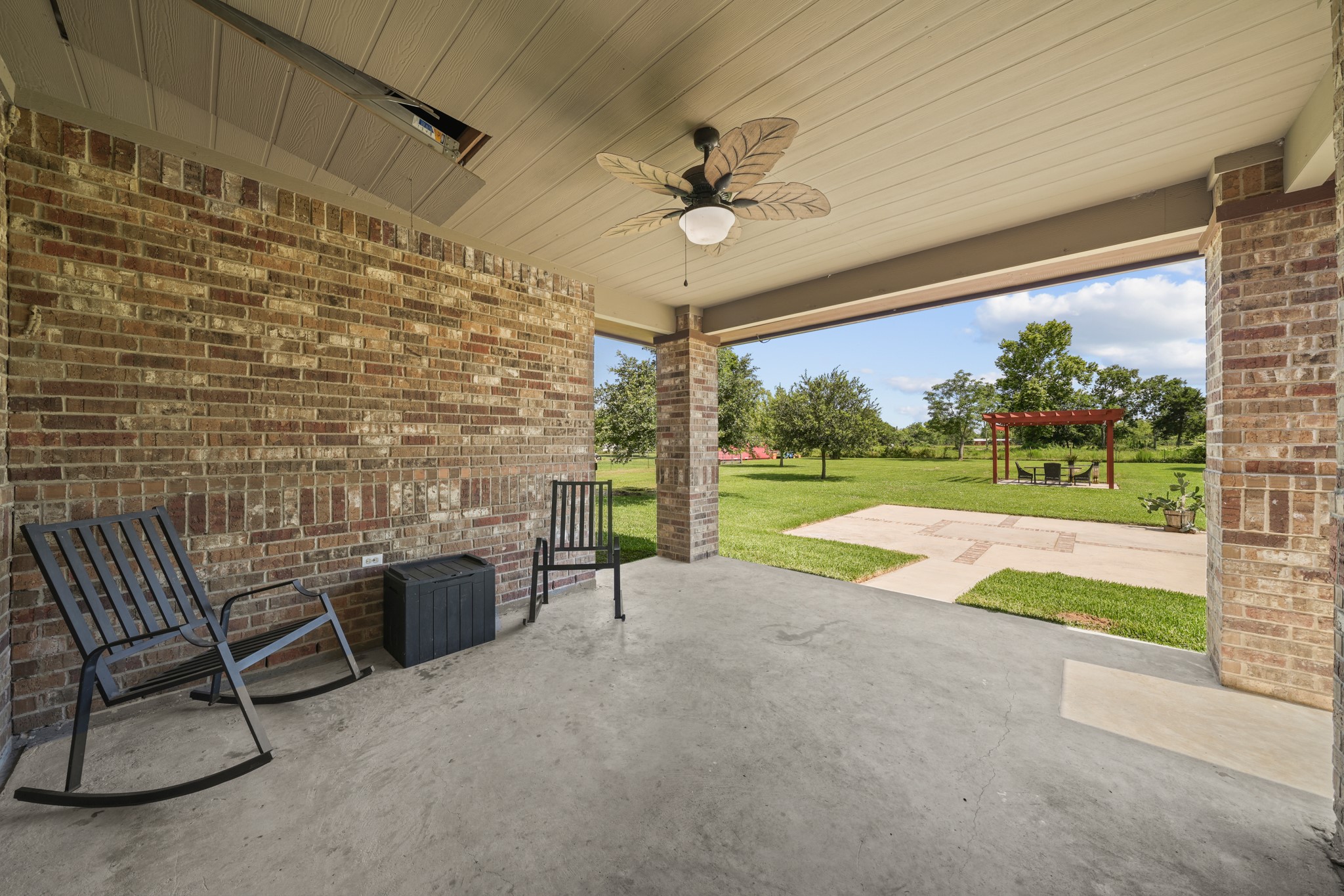 Covered Patio: Ground-level view looking out from the back patio