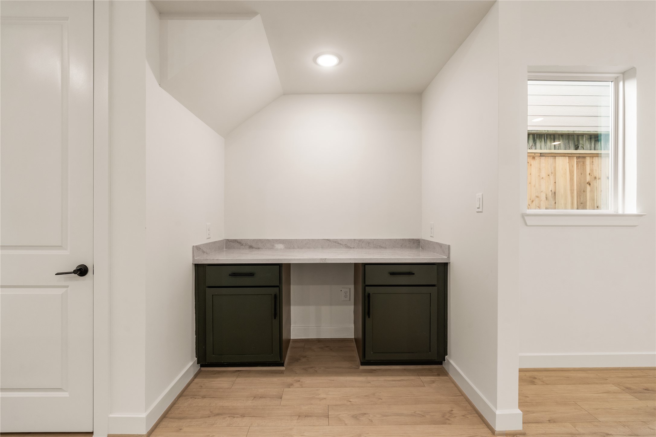 Built-in bar  custom niche featuring dark cabinetry, quartz countertop.
