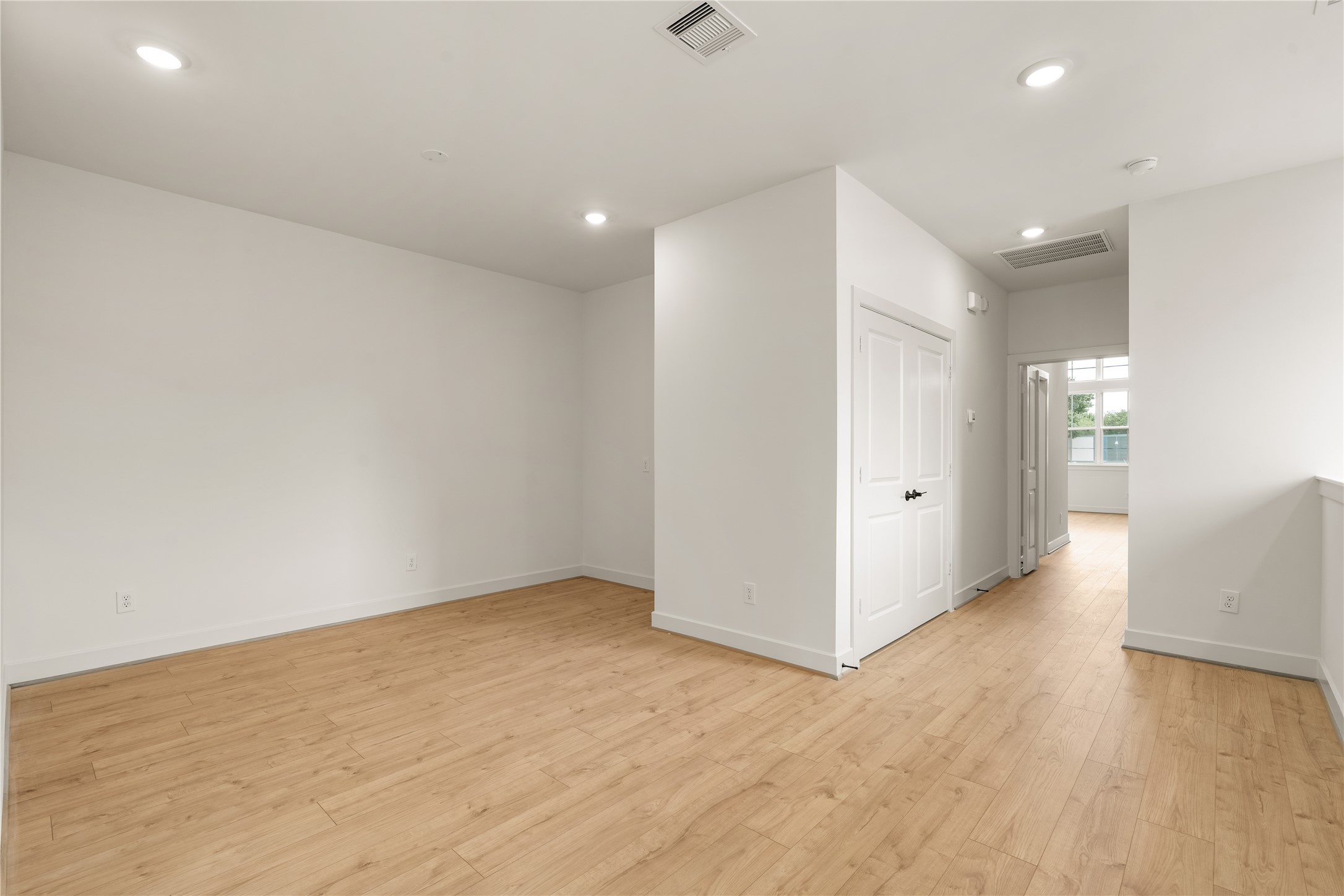 Versatile upper hall layout  recessed lighting, smooth drywall finish, and seamless access to bedrooms and secondary baths.