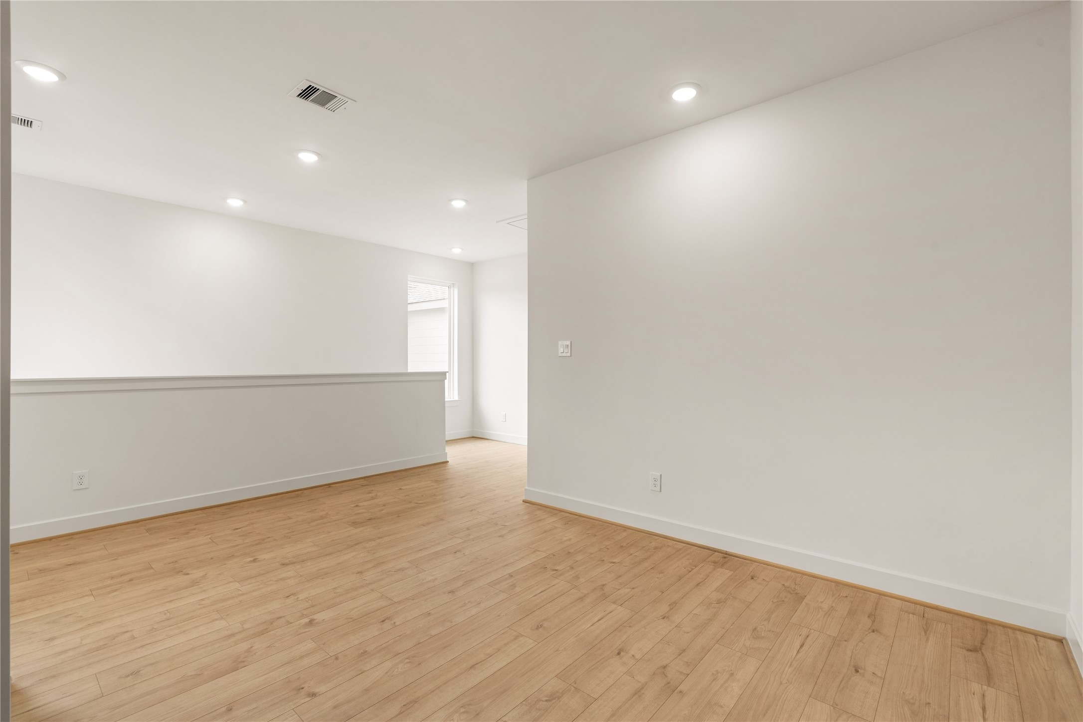 Flexible upstairs loft  ideal second living area or game room setup with clean trim details and ample wall space.