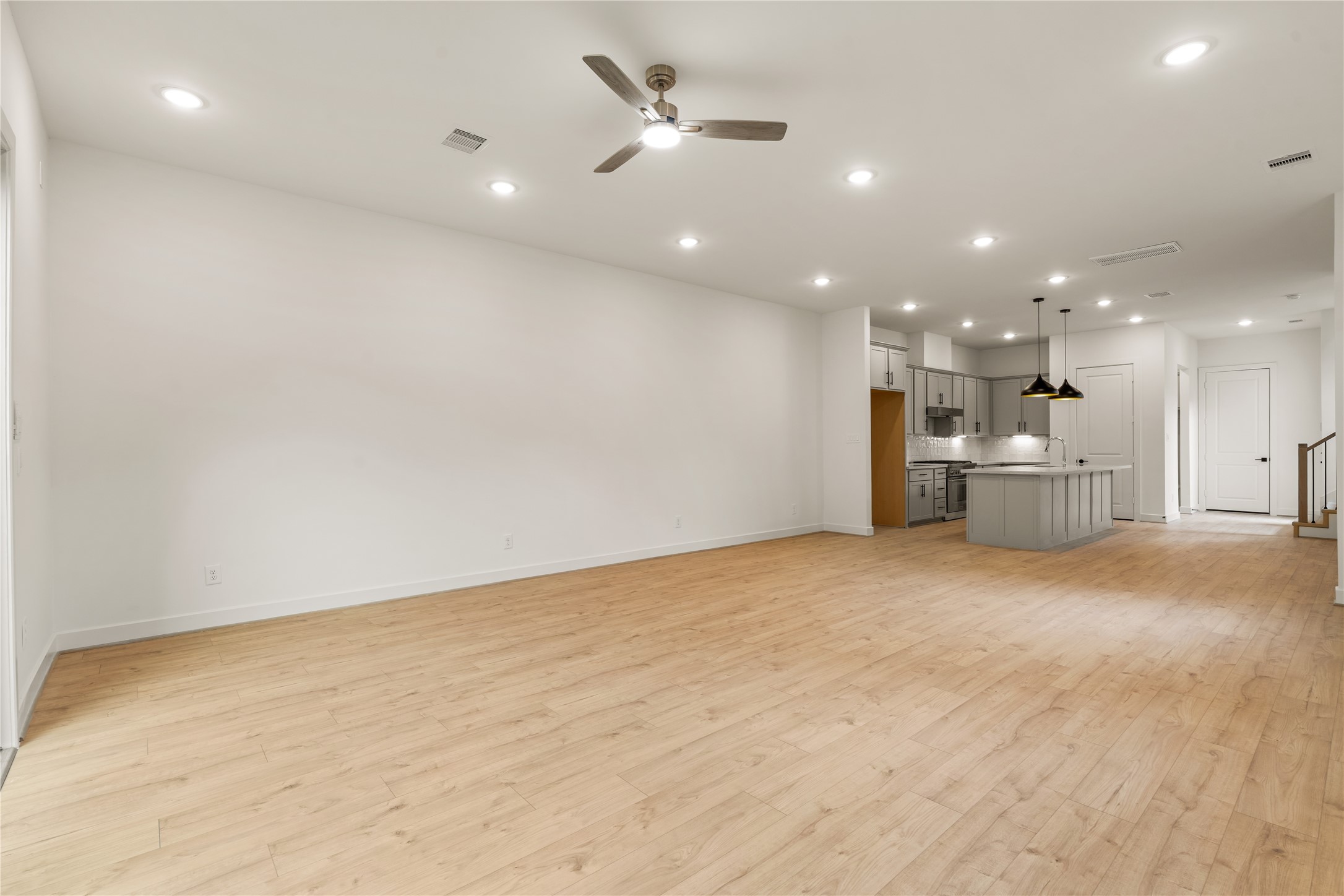 Seamless main floor flow  sprawling living zone leading directly into the chef's kitchen, perfect for effortless entertaining.