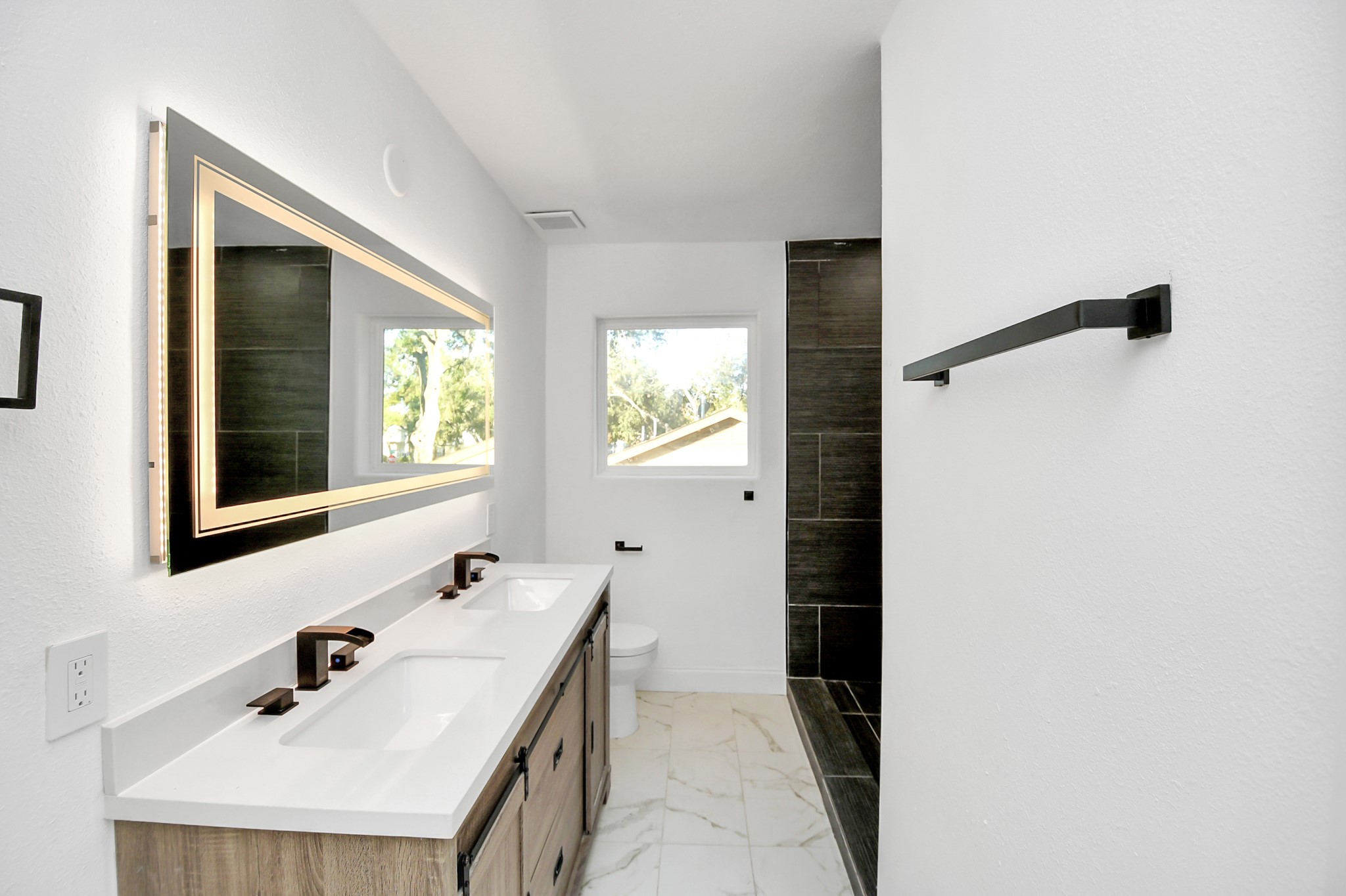 Around the corner you will find a sleek walk-in shower.