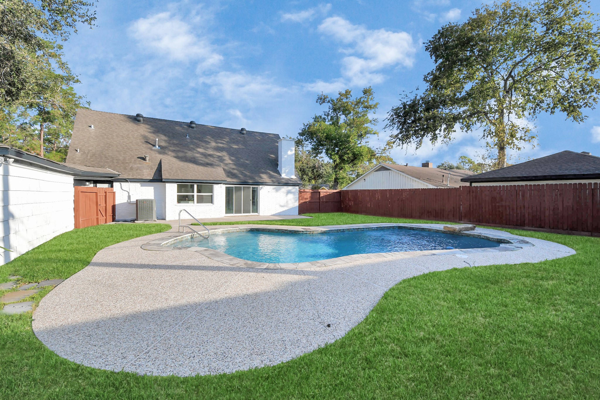 A paved area alongside the pool provides the perfect spot for lounge chairs, inviting you to relax and soak up the sun.
