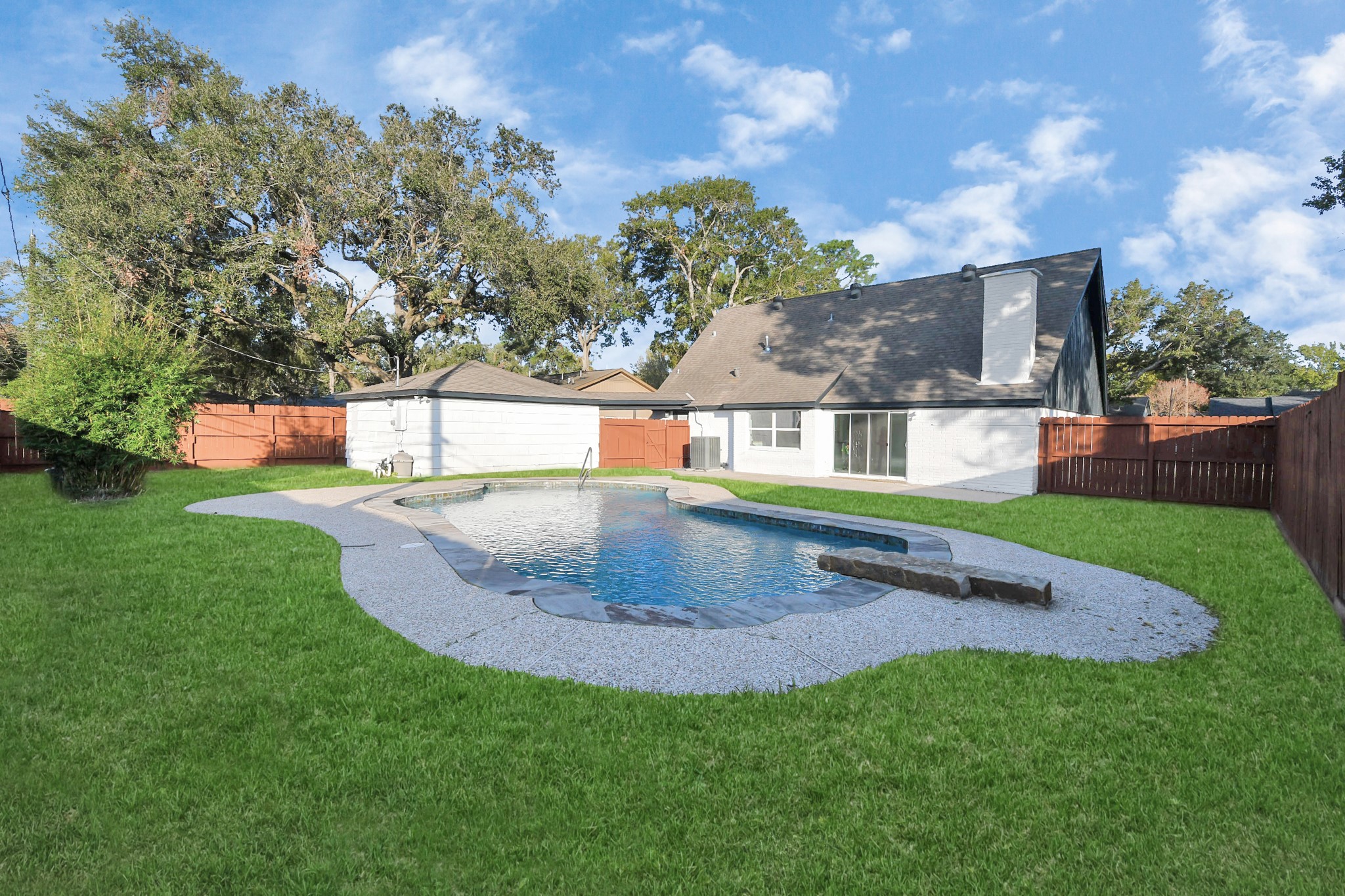 The massive backyard boasts an oversized, luxurious pool, perfectly designed for enjoying those hot Texas summers.