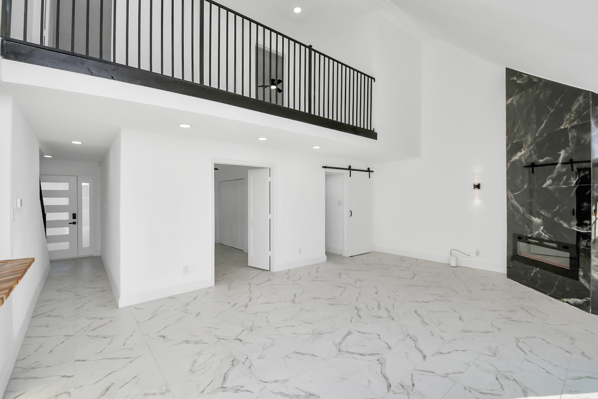 A wrought iron railing accents the catwalk, enhancing the home's architectural charm and overall appeal.