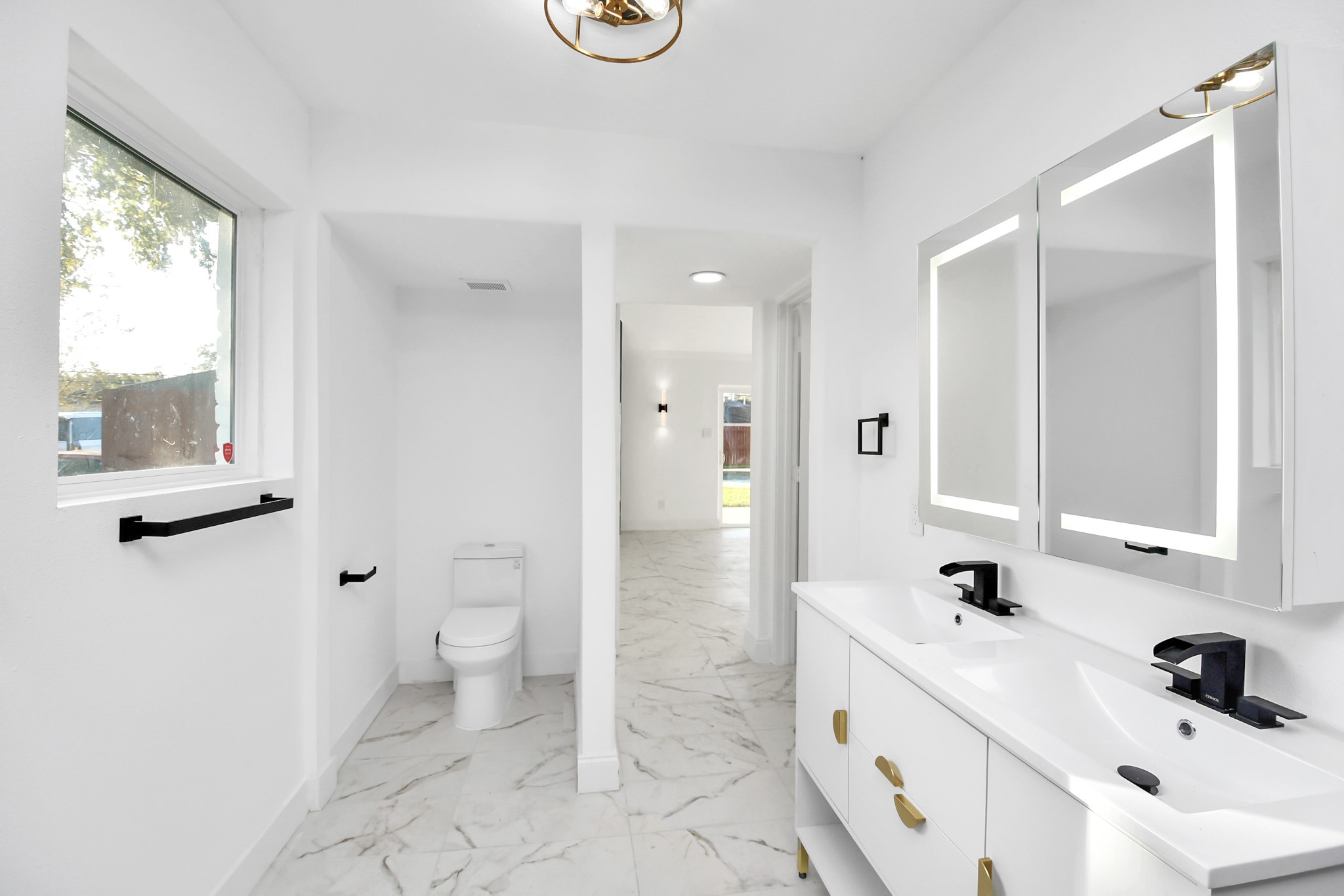 Dual sinks and black hardware round out this bathroom.
