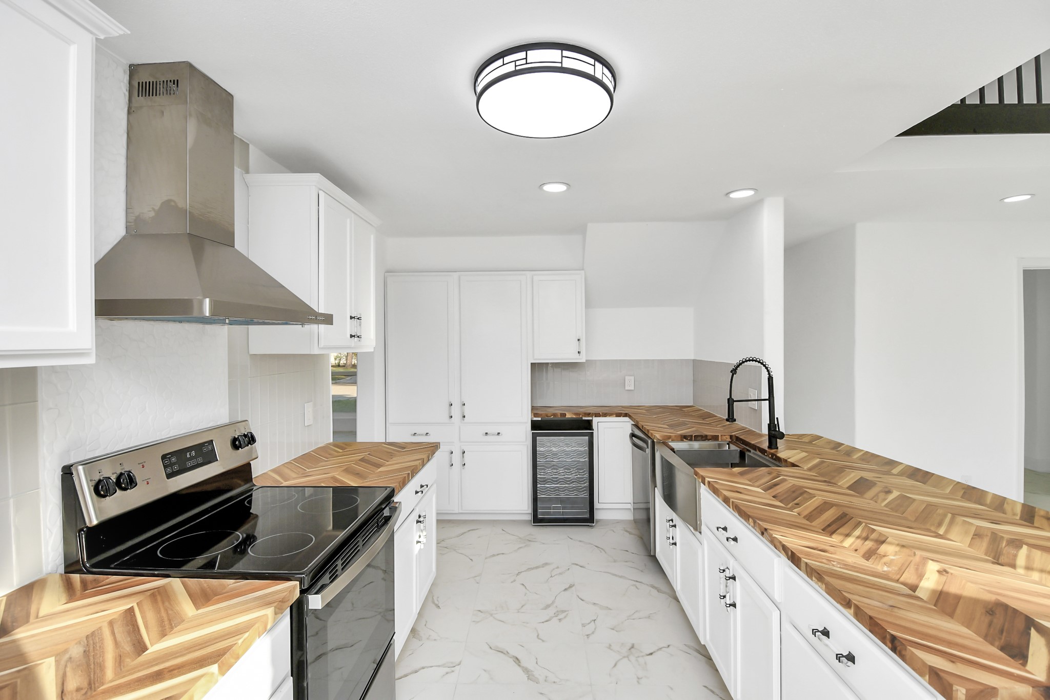 A tucked-away wine fridge, conveniently located near the dining room, adds a touch of luxury and practicality to the already impressive gourmet kitchen.