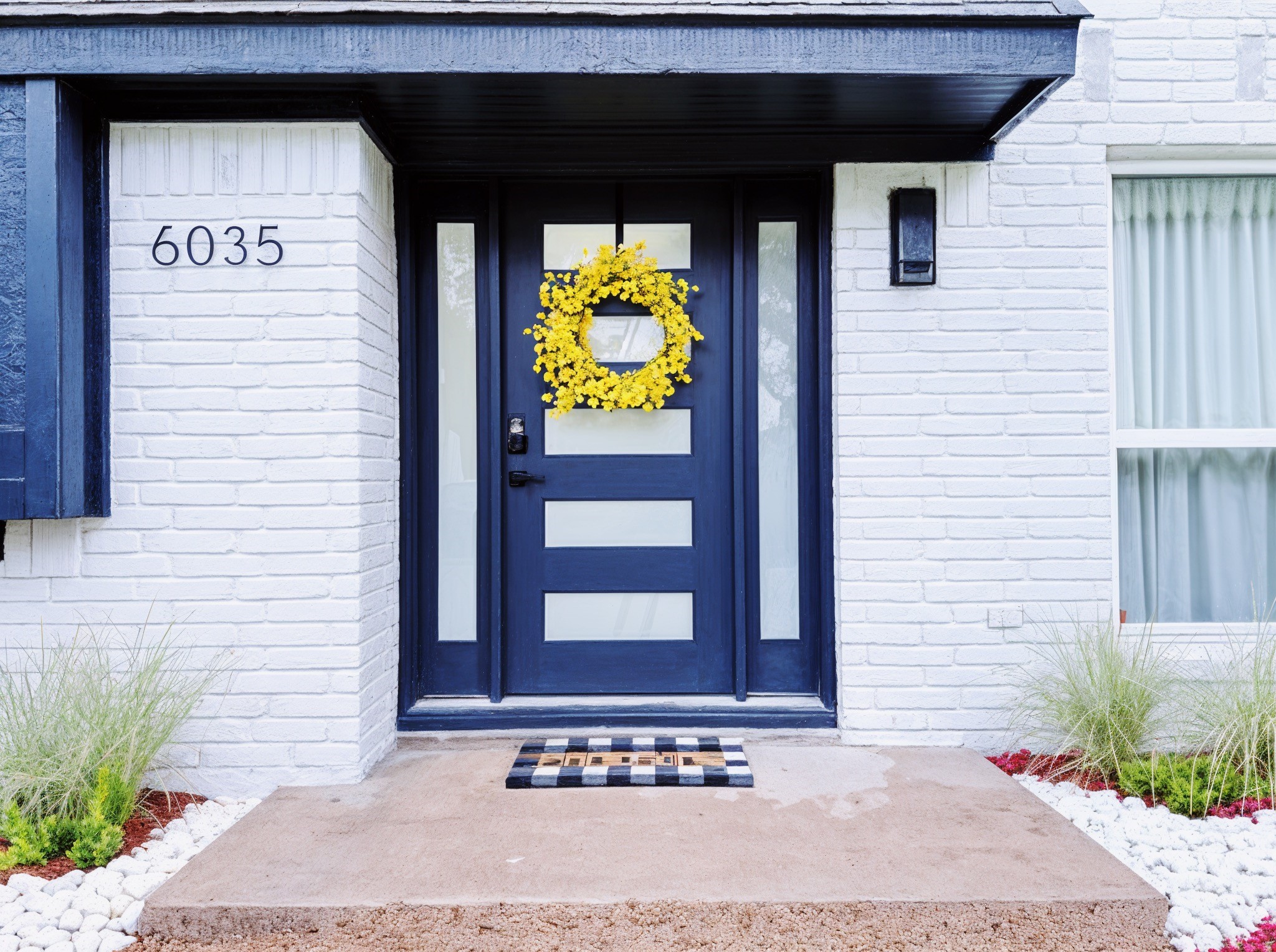 A vibrant color option for the  front door adds to curb appeal and welcomes you inside this gorgeous modern home.