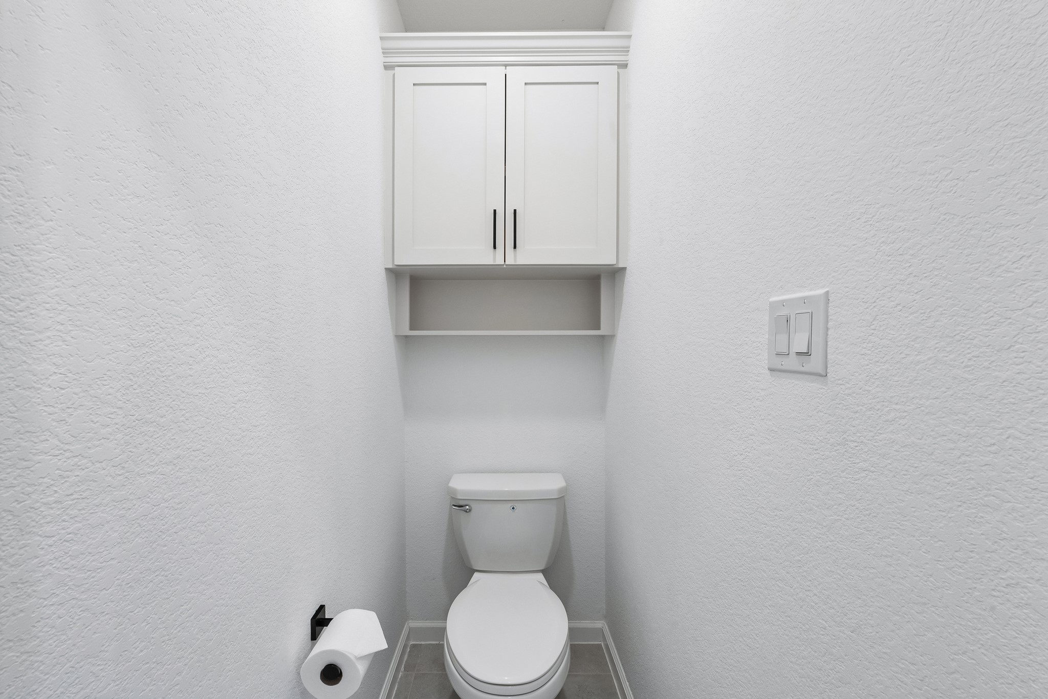 Additional storage was added in the water closet.