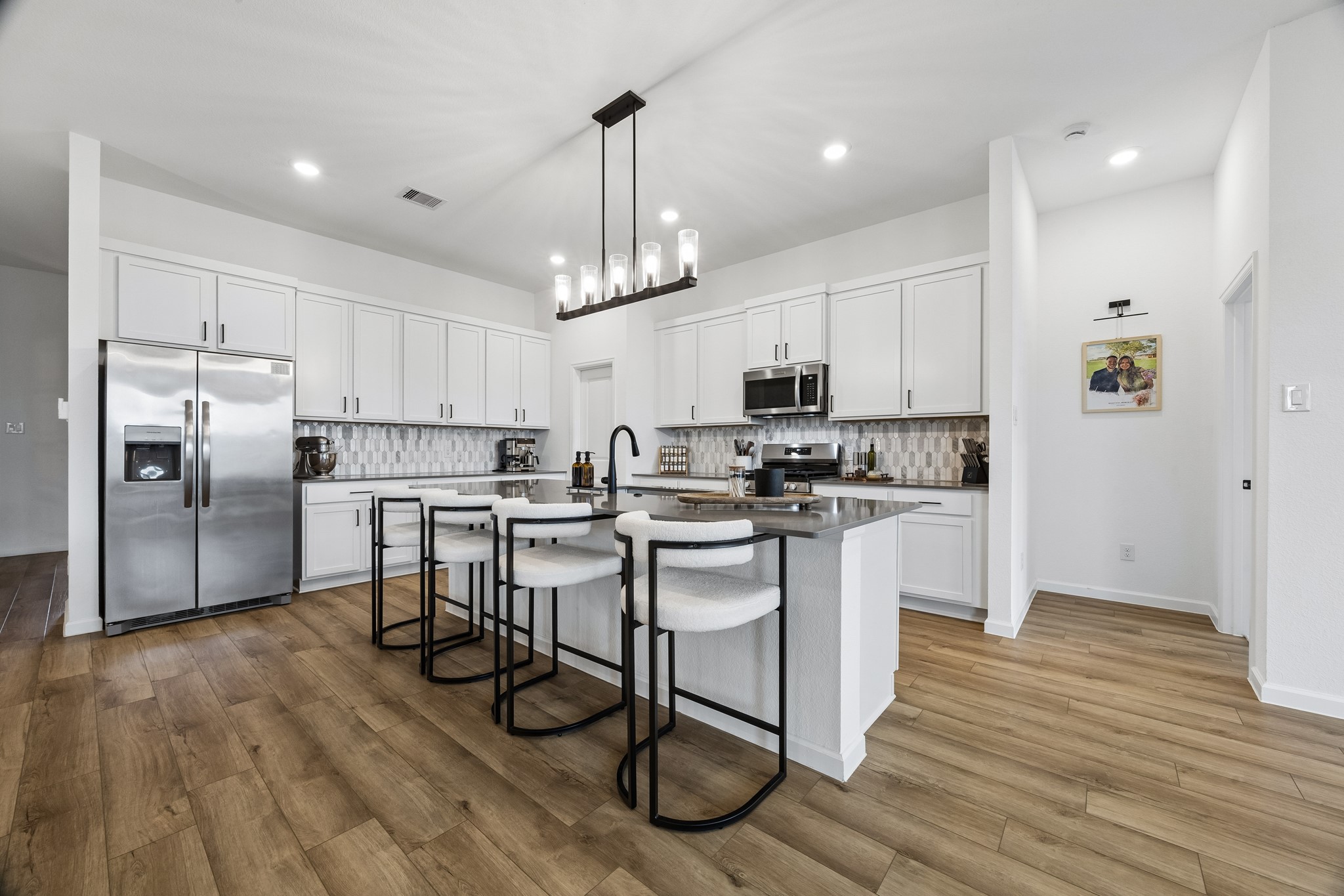 Ample storage with cabinets and walk-in pantry.