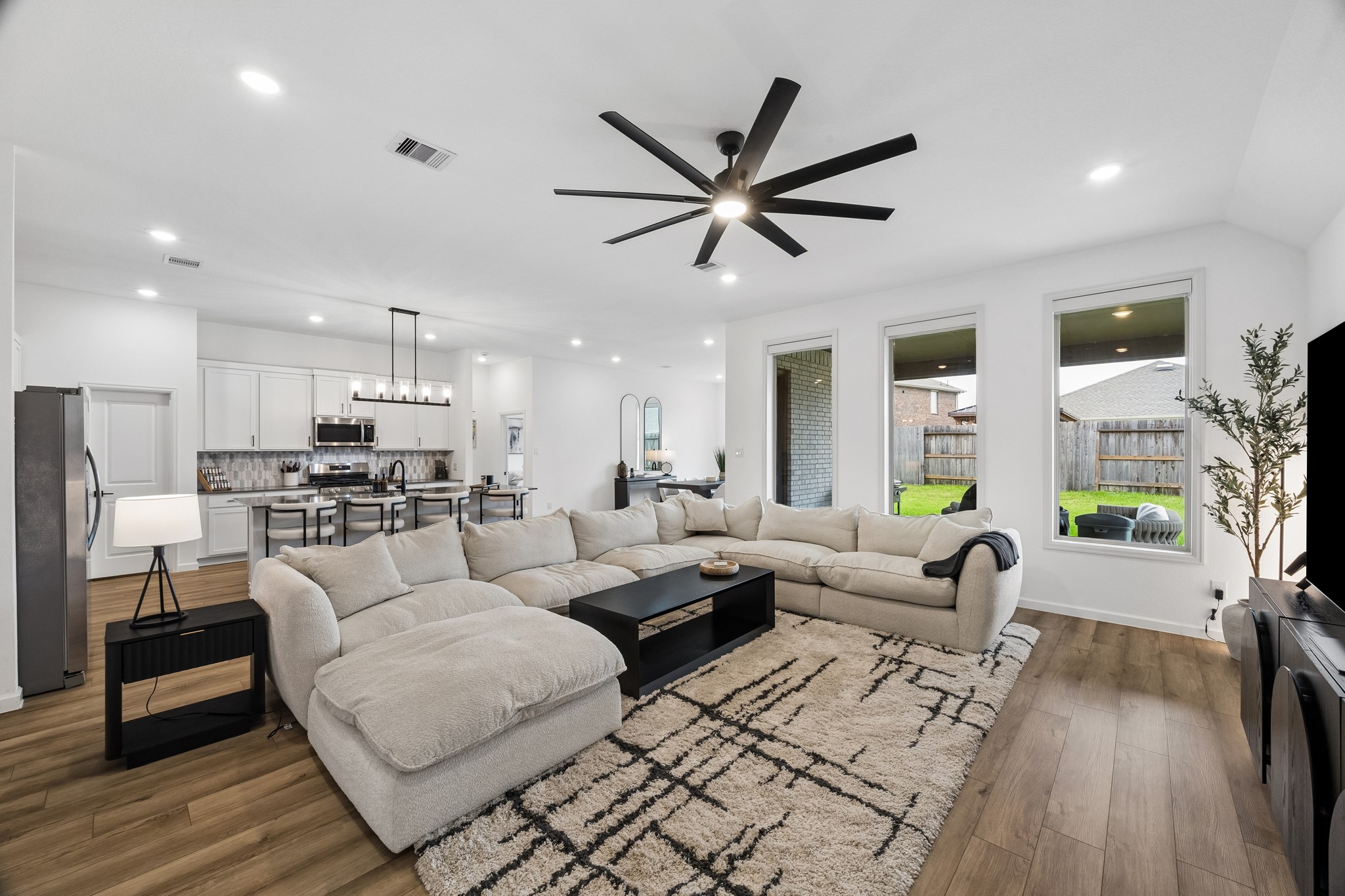 Another view of the living room, kitchen and formal dining room.