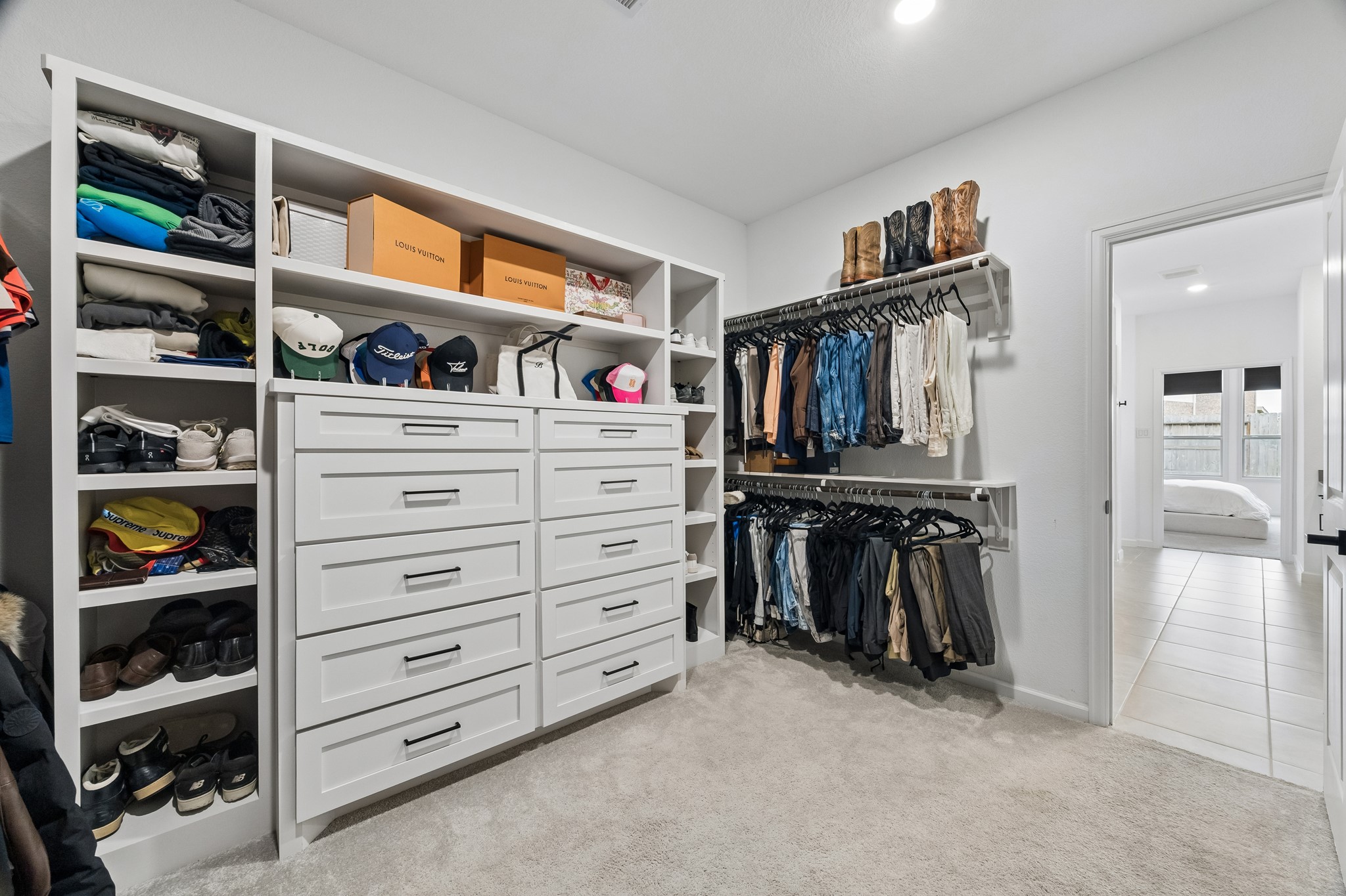 The primary closet had built-in shelves and cabinets added for ample organizaion and storage. There was also shelves added above each hanging rack.