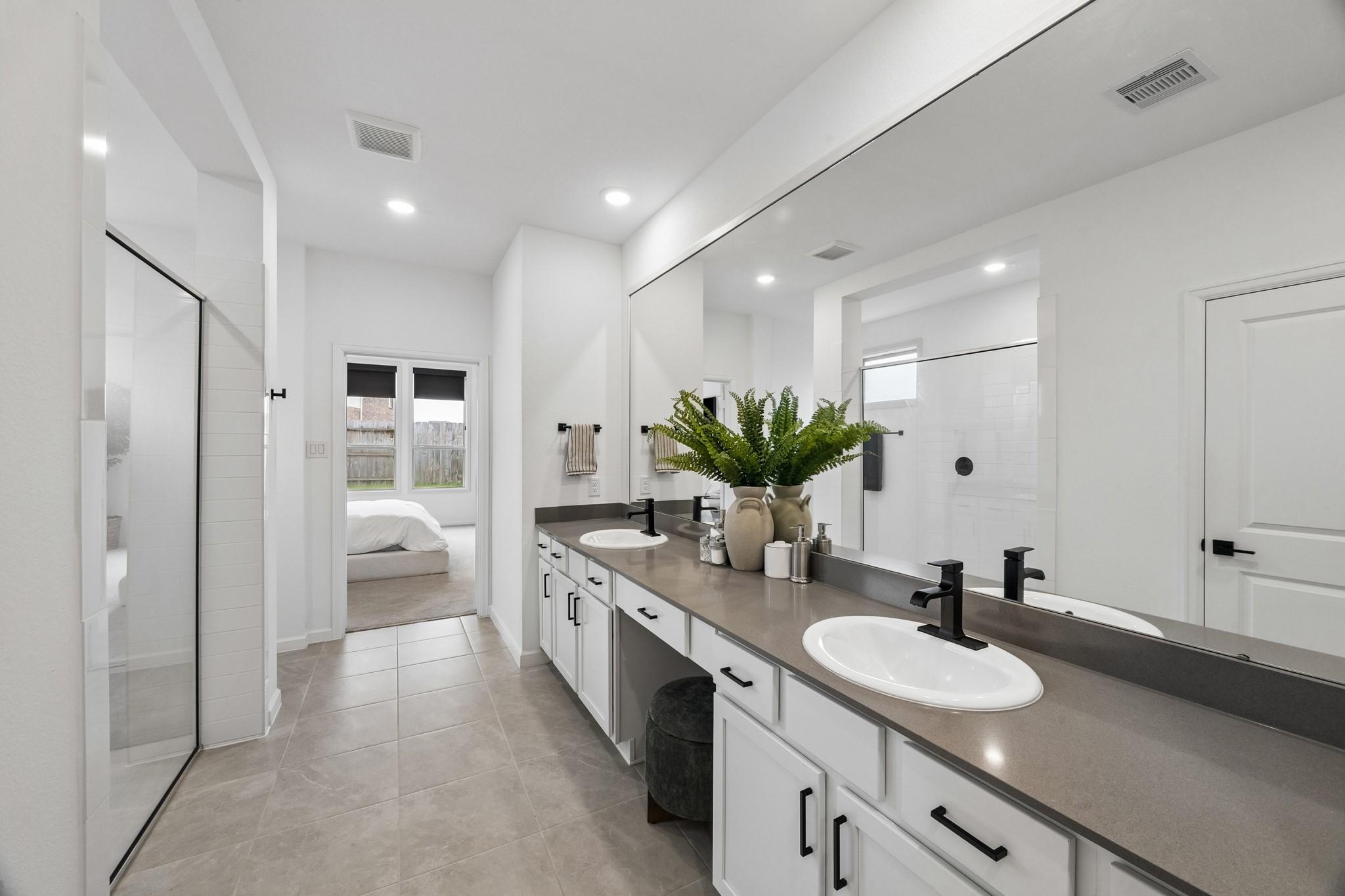 Another view of the primary bath. The mirror features a framed design the owner thoughtfully added.