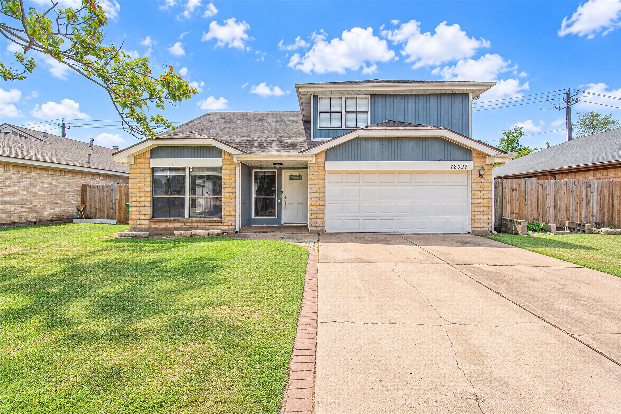 Charming two-story home with a spacious driveway and inviting front yard. The exterior features a mix of brick and siding, complemented by a two-car garage and large front windows for ample natural light. Charming two-story home with a spacious driveway and inviting front yard. The exterior features a mix of brick and siding, complemented by a two-car garage and large front windows for ample natural light.