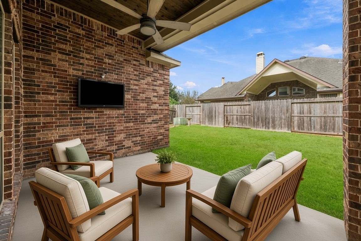 virtually staged - Covered patio w/ TV and ceiling fan