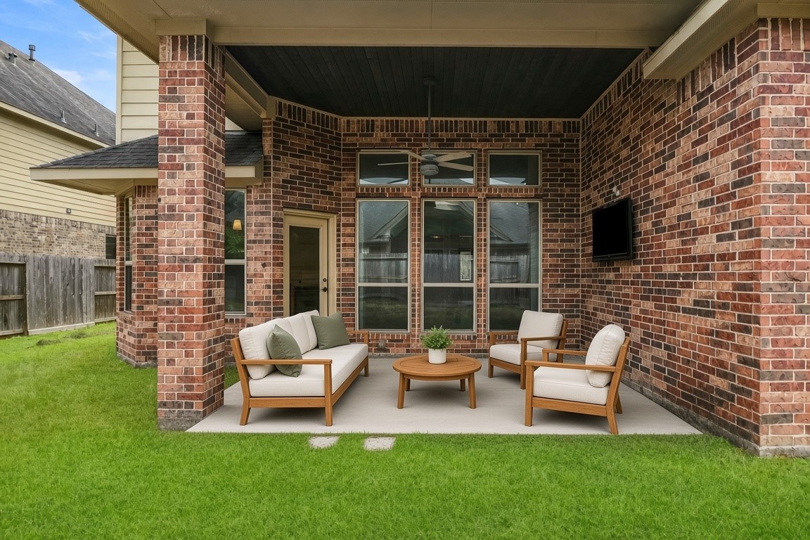 virtually staged - Covered patio w/ TV and ceiling fan