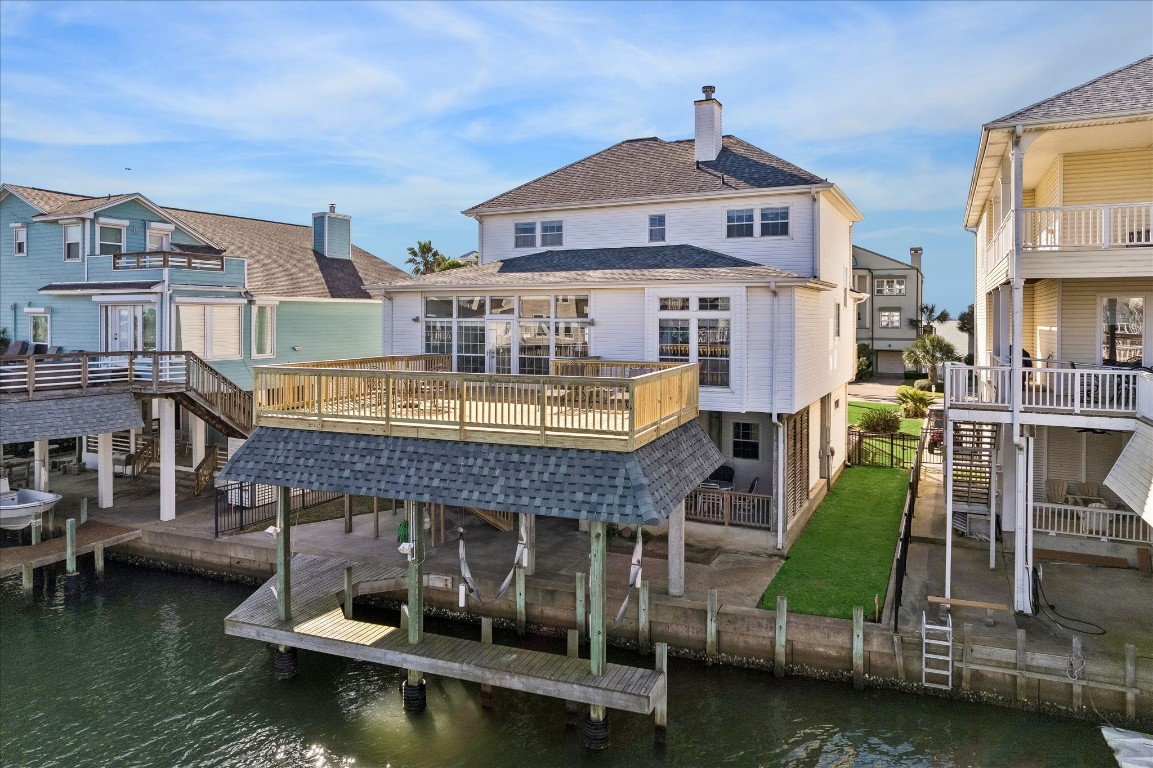 This waterfront home features a spacious deck overlooking the canal, providing direct water access. It offers a modern design with large windows for natural light, a small backyard, and is situated in a picturesque neighborhood ideal for boating enthusiasts.