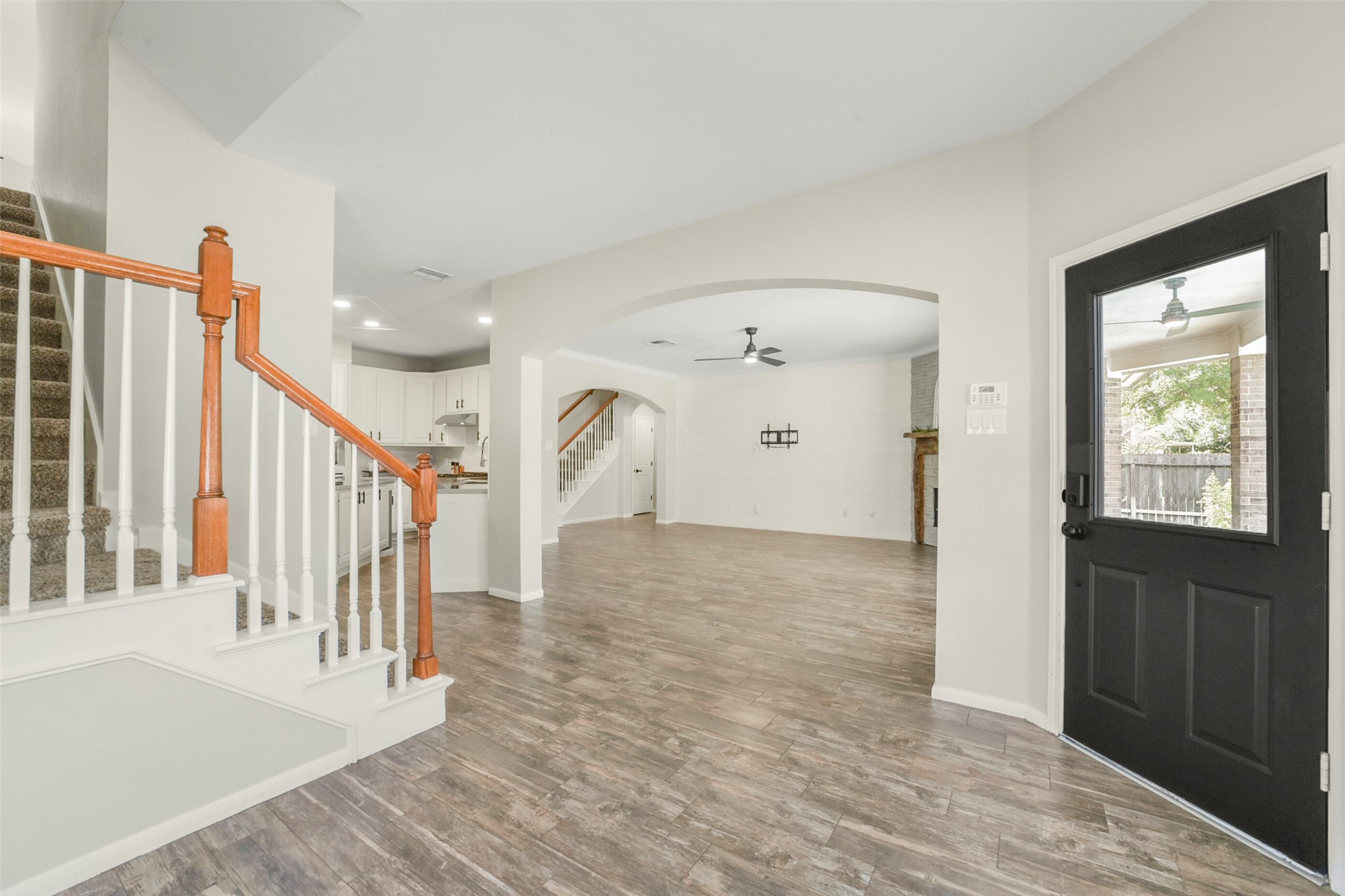 Spacious open-concept living area, seamlessly connects to a stylish kitchen with a breakfast bar. this layout offers easy access to both the upstairs and a welcoming entryway.