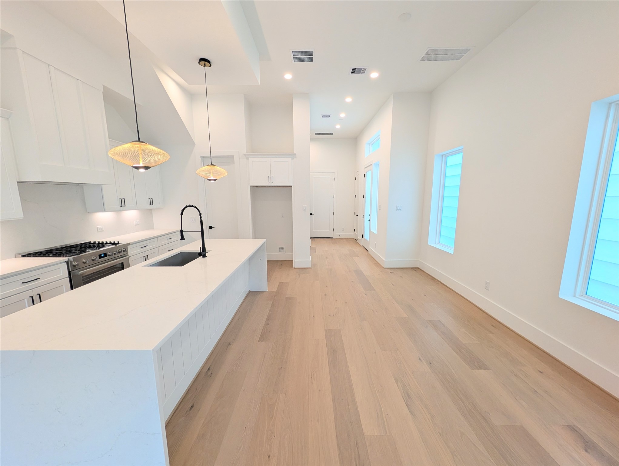 Reverse view of dining area from the living room with large bar area with room for stools.