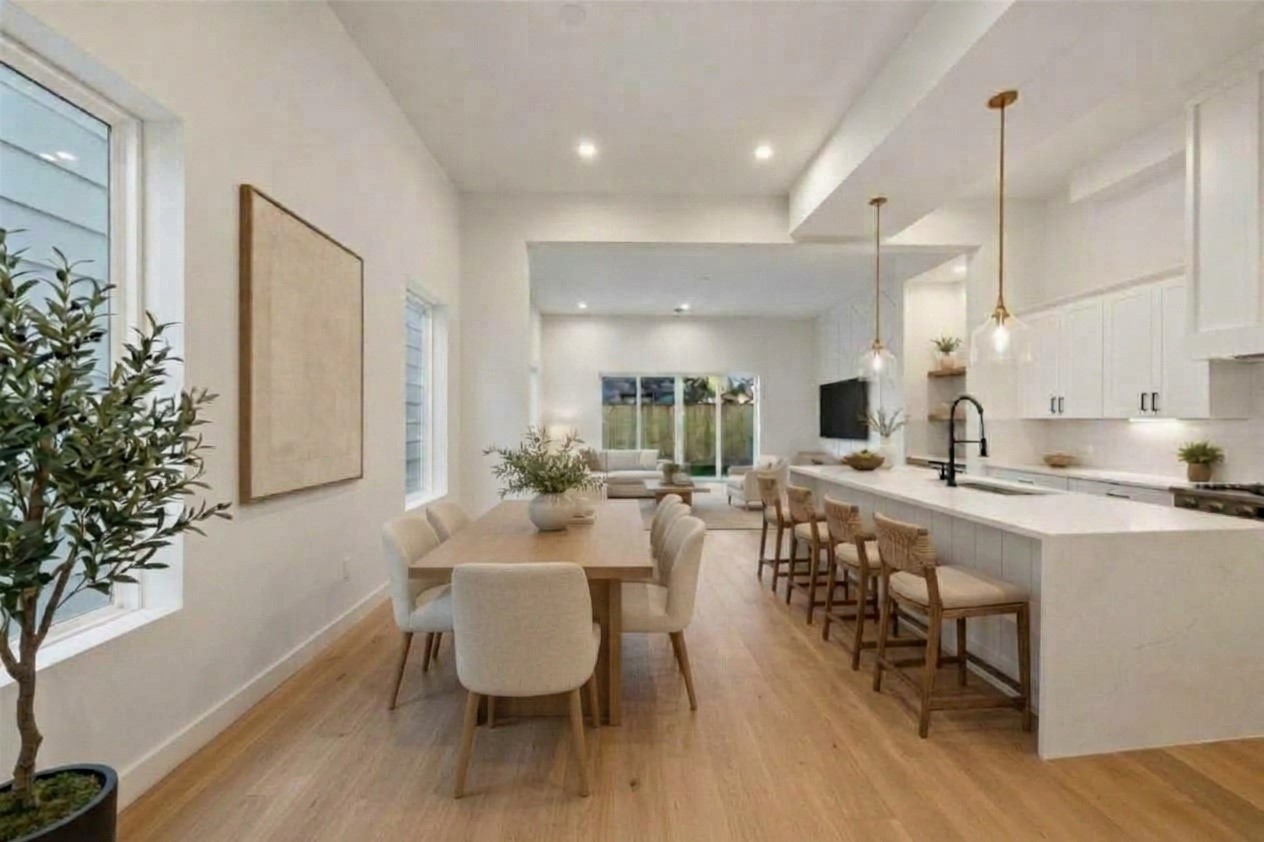 Spacious open dining area paired with a sleek kitchen island and built-in bar seatingperfect for hosting and everyday living