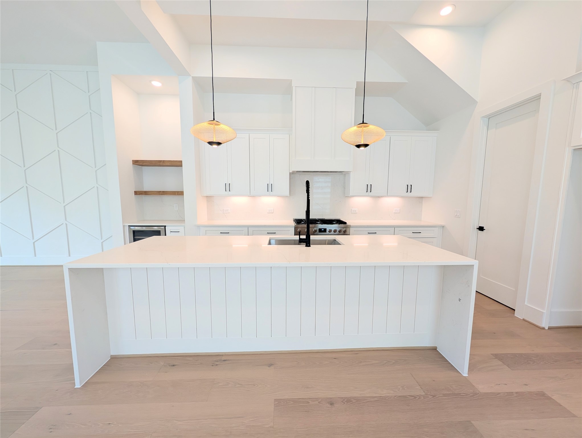 Beautifully finished modern chef's kitchen with huge island and sleek dimmable lighting