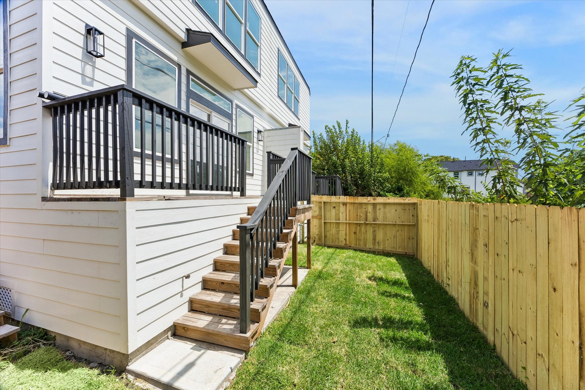 Each unit offers a private fenced area and balcony with stairs leading down.