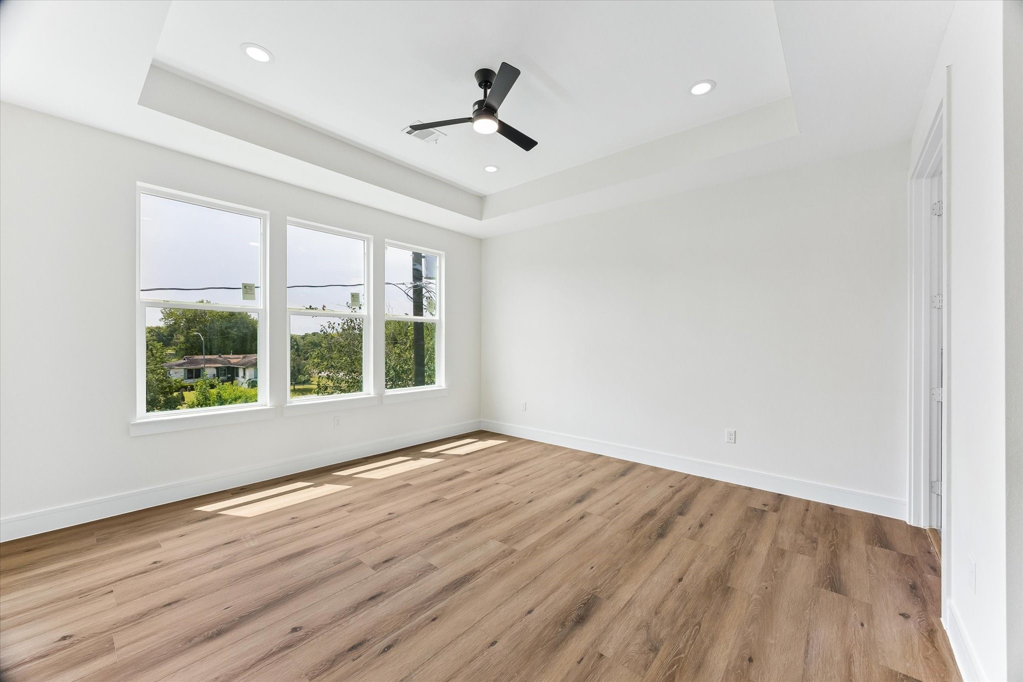 Primary bedroom with laminate flooring.