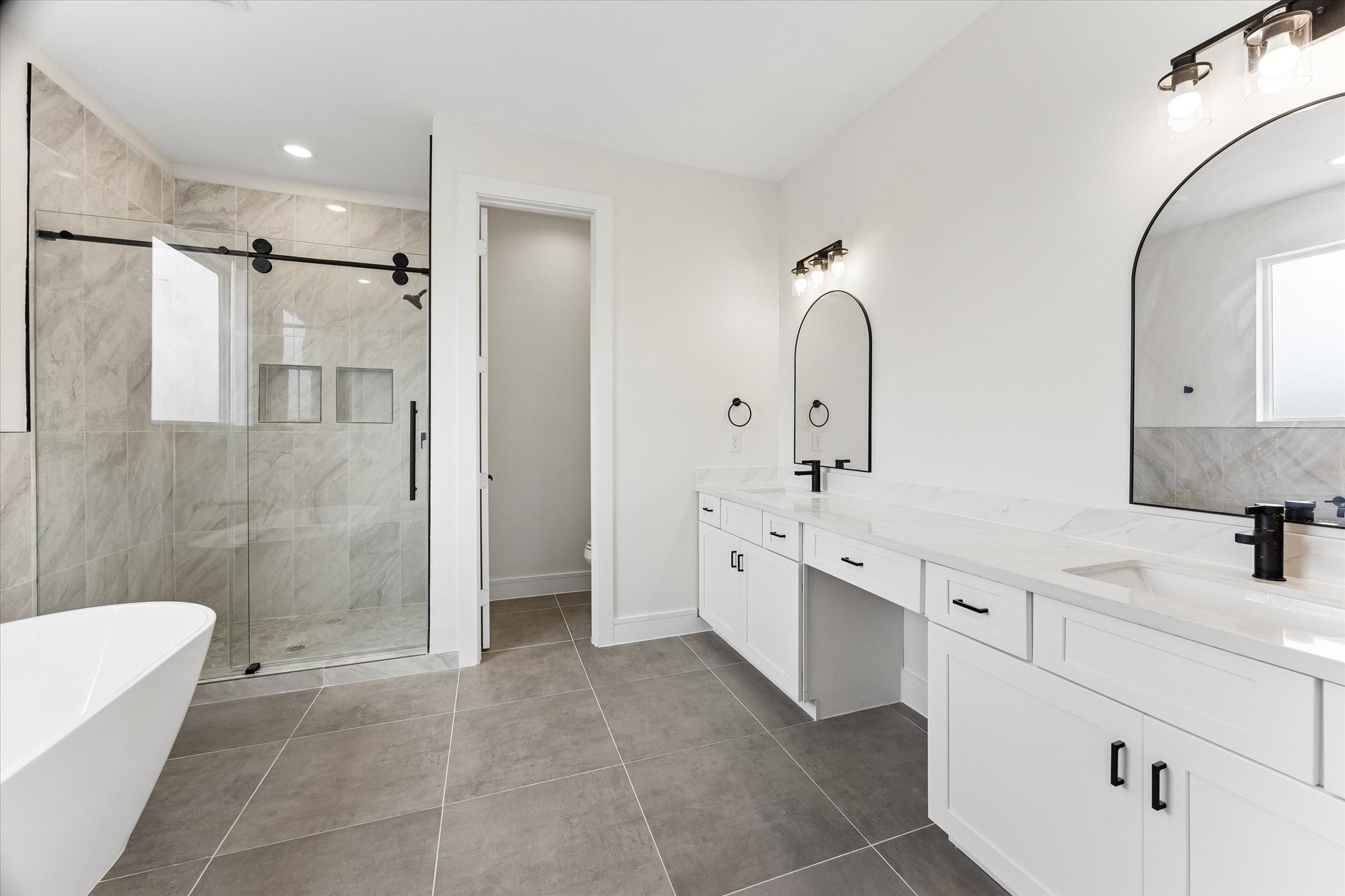 Primary bathroom offering both a tub and separate shower.