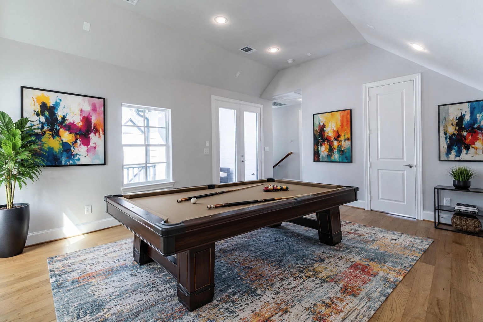 Bright third-floor game room leads out to the wrap-around rooftop terrace.  Virtual staging added.