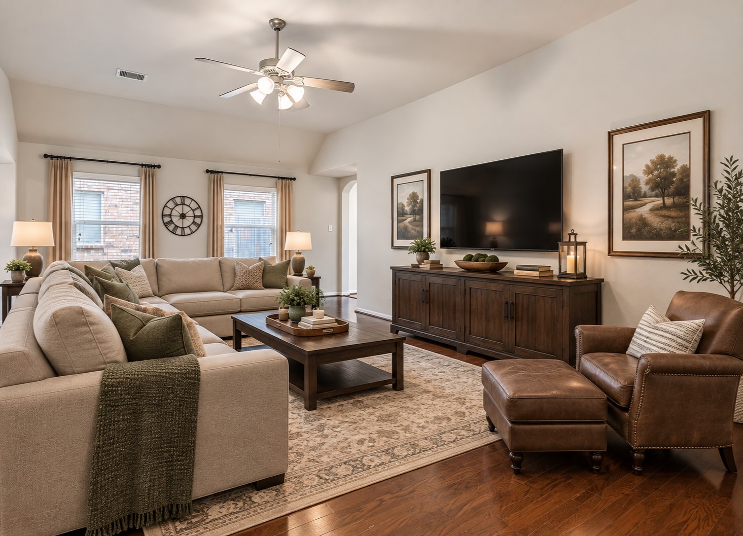 Another view showcases the generous proportions of the family room, with plenty of space for multiple seating arrangements, wood flooring and a high ceiling creating an airy, comfortable gathering space.