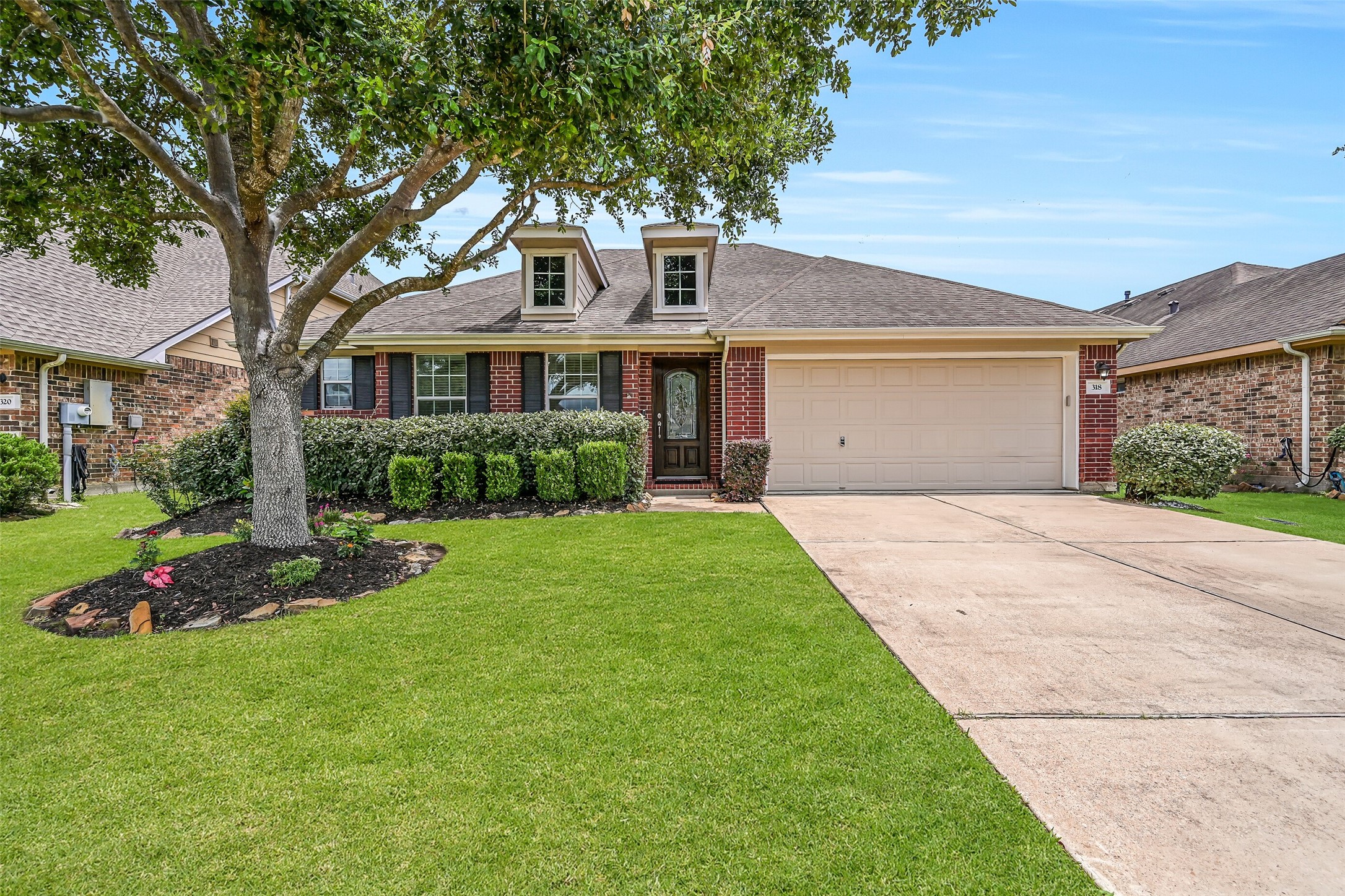 Welcome to 318 Lake Line Drive in Alvin's Kendall Lakes! This charming single-story brick home features mature landscaping, a double-wide driveway, 2-car attached garage & distinctive dormer windows, all framed by a beautiful mature shade tree.
