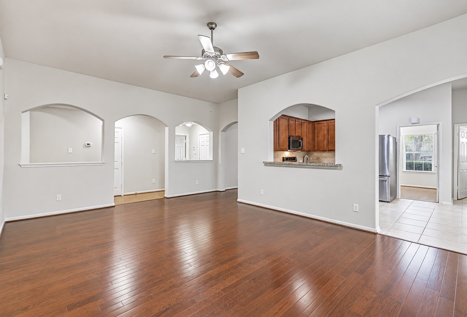 From this angle, the family room highlights the home's easy flow, with arched openings and a granite-topped pass-through providing an open connection to the kitchen, breakfast area and surrounding living spaces.