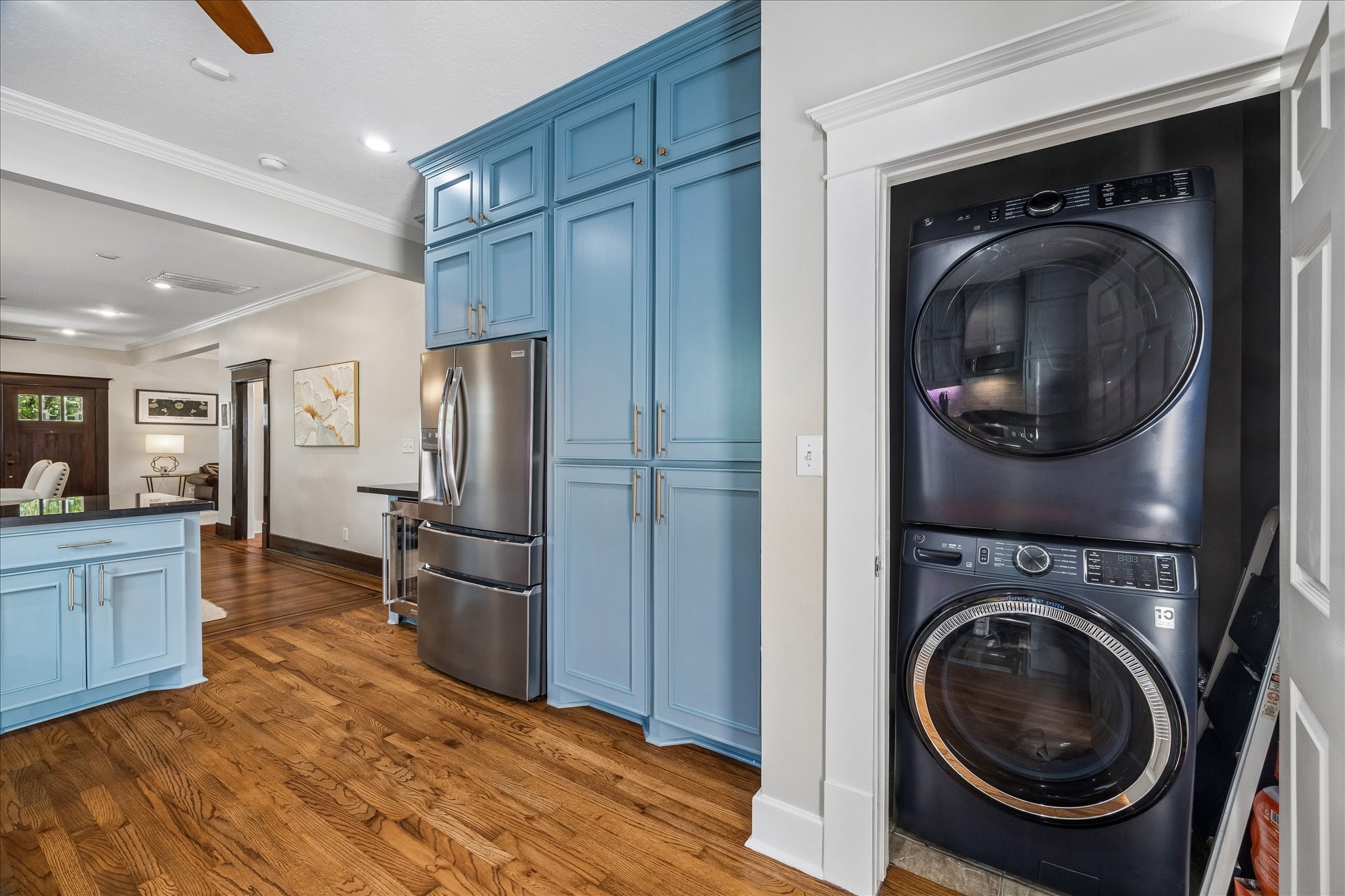 Convenient in-home utility closet with modern stacked washer and dryer.