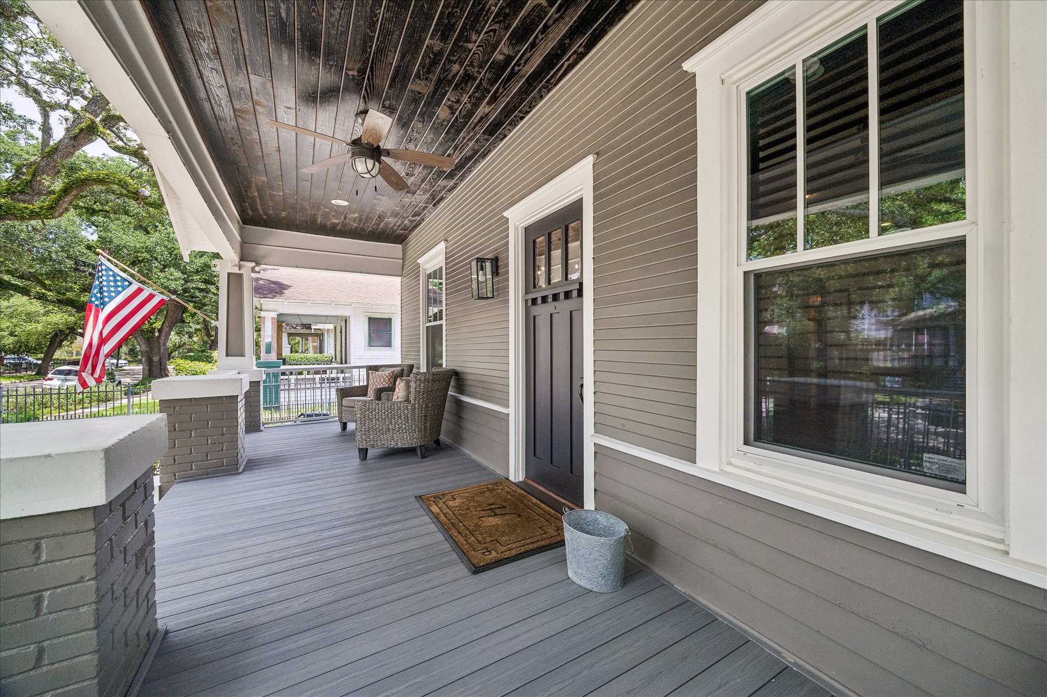 Charming shaded front porch, perfect for a cozy swing.