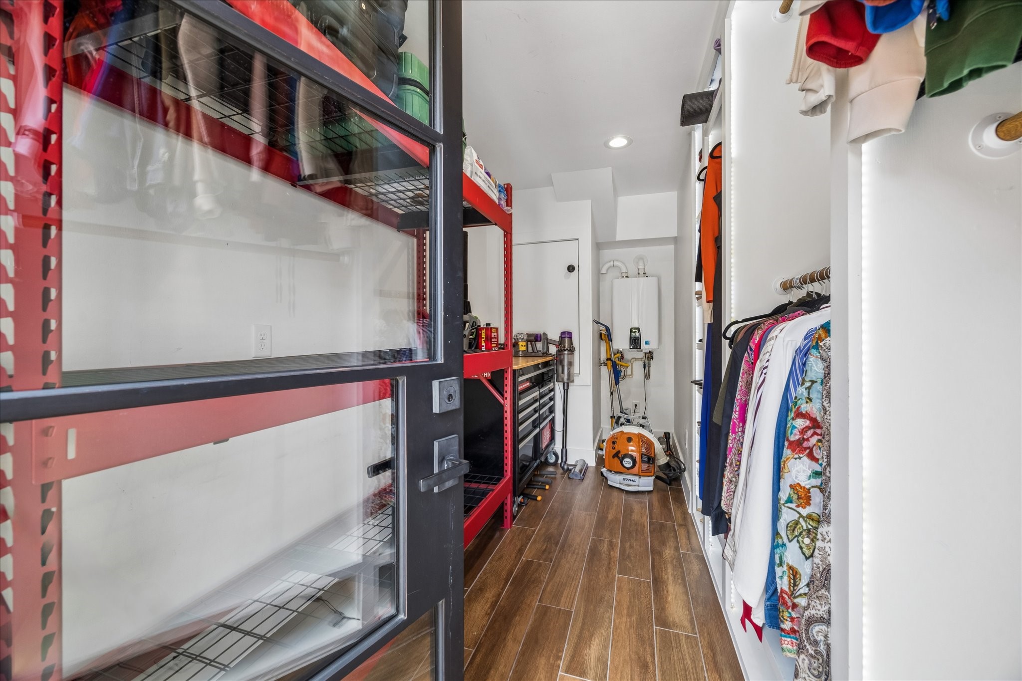 Spacious storage room with organized shelving and ample hanging space.