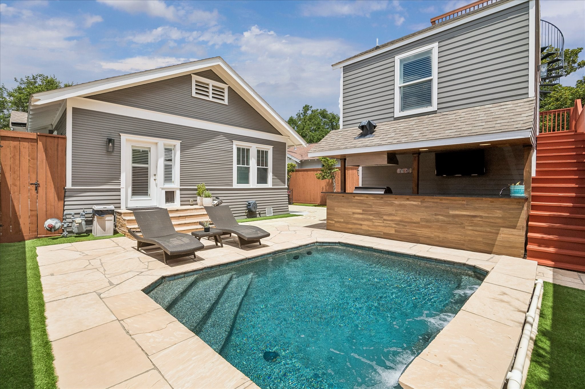 Experience year-round relaxation with this stunning heated pool oasis.