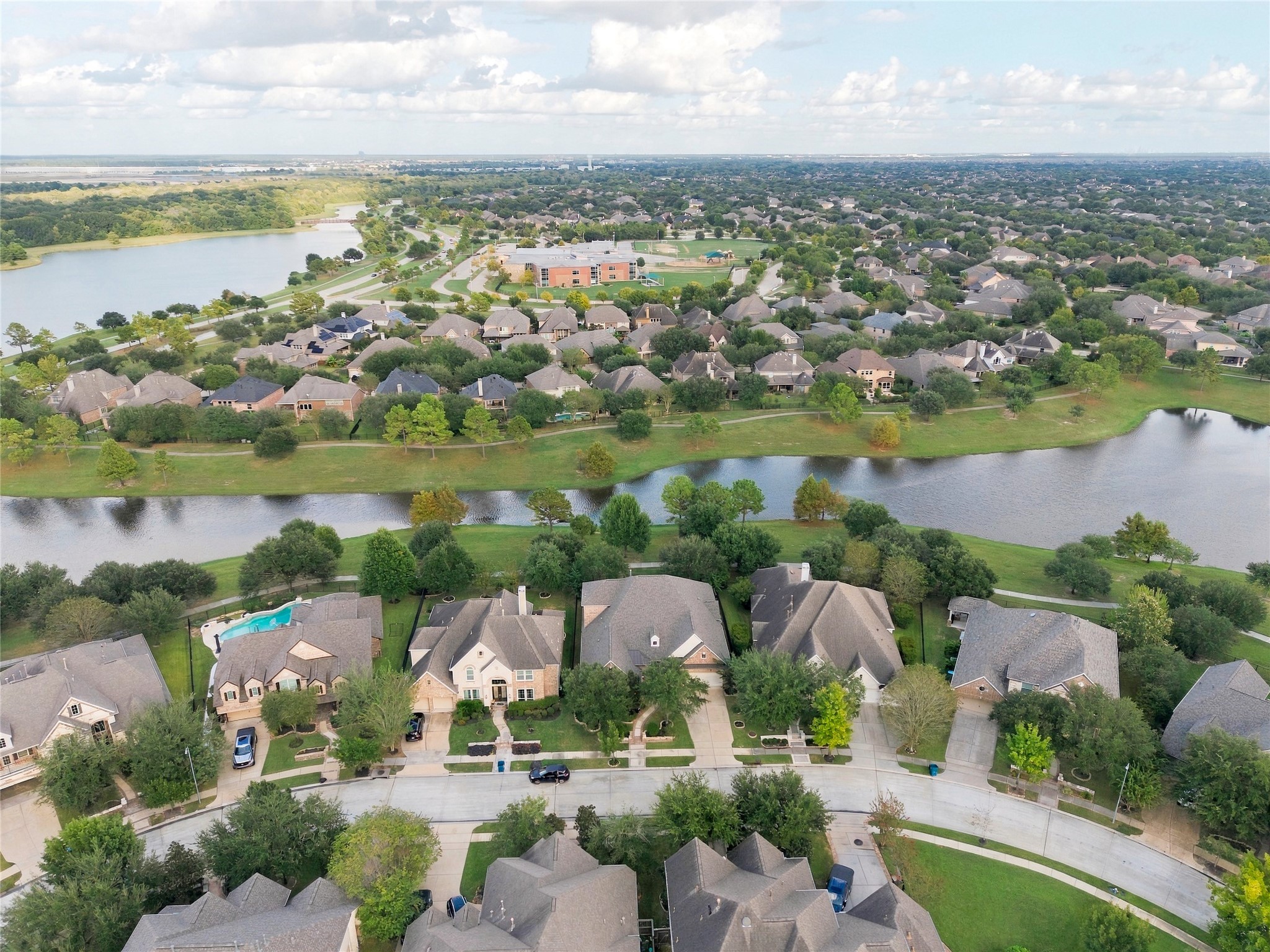 Phenomenal aerial view showcasing the home's waterfront location and the scenic surroundings of Water Haven at Bridgeland.