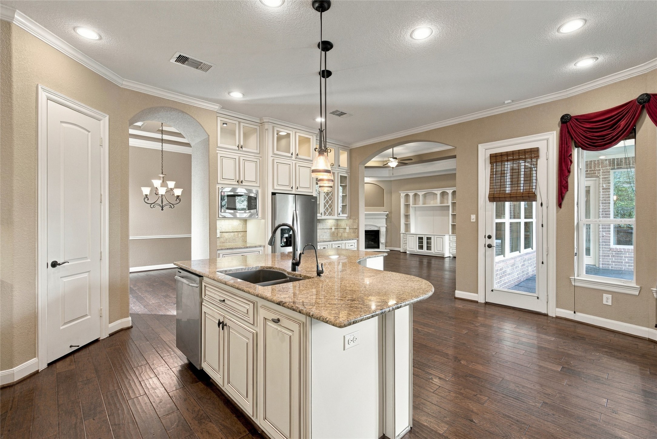 This inviting kitchen offers a functional layout with plenty of counter space, a gas cooktop, stainless steel appliances, and convenient access to the living areas.