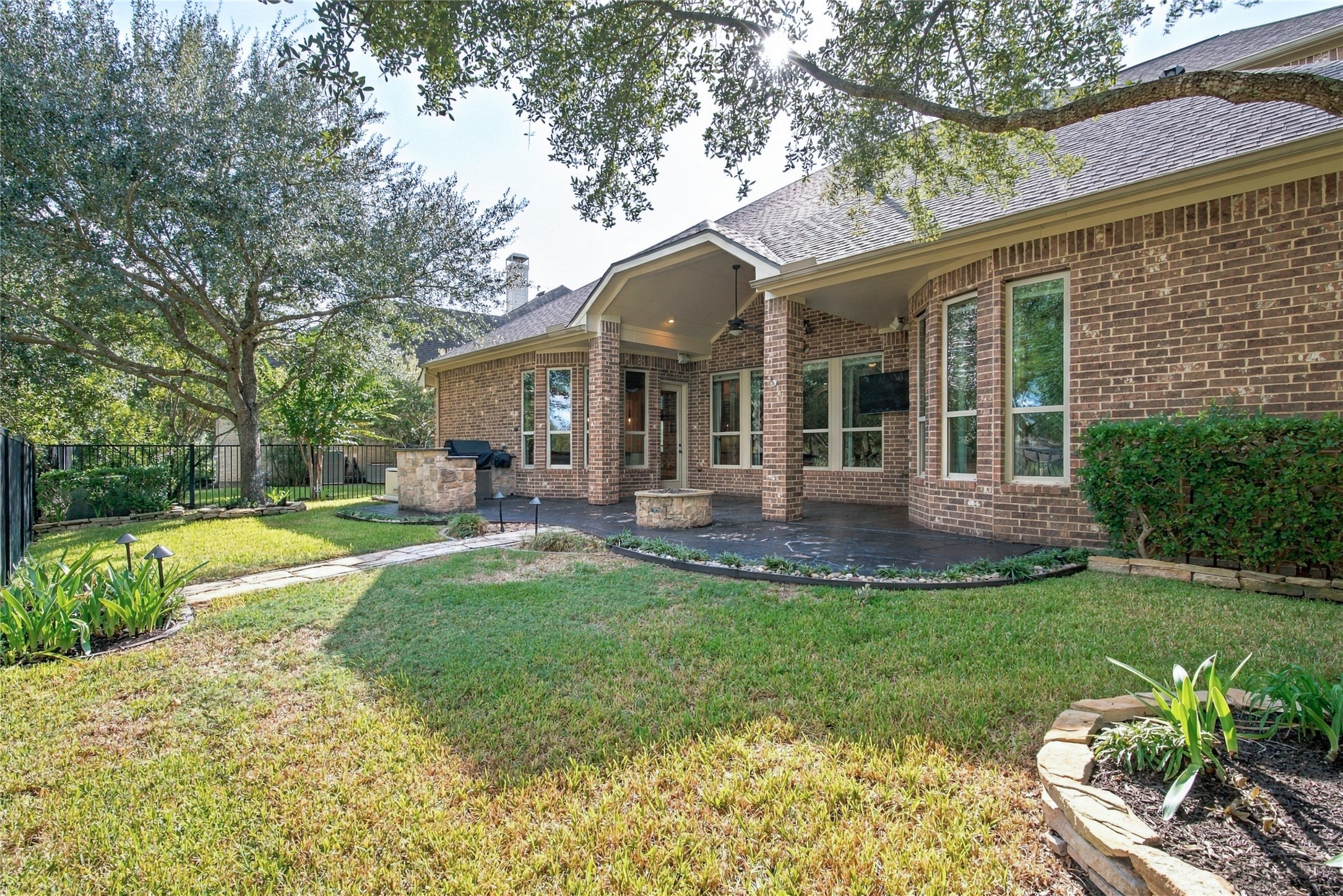 Enjoy outdoor living with an extended patio, outdoor kitchen, and beautifully landscaped backyard overlooking the water.