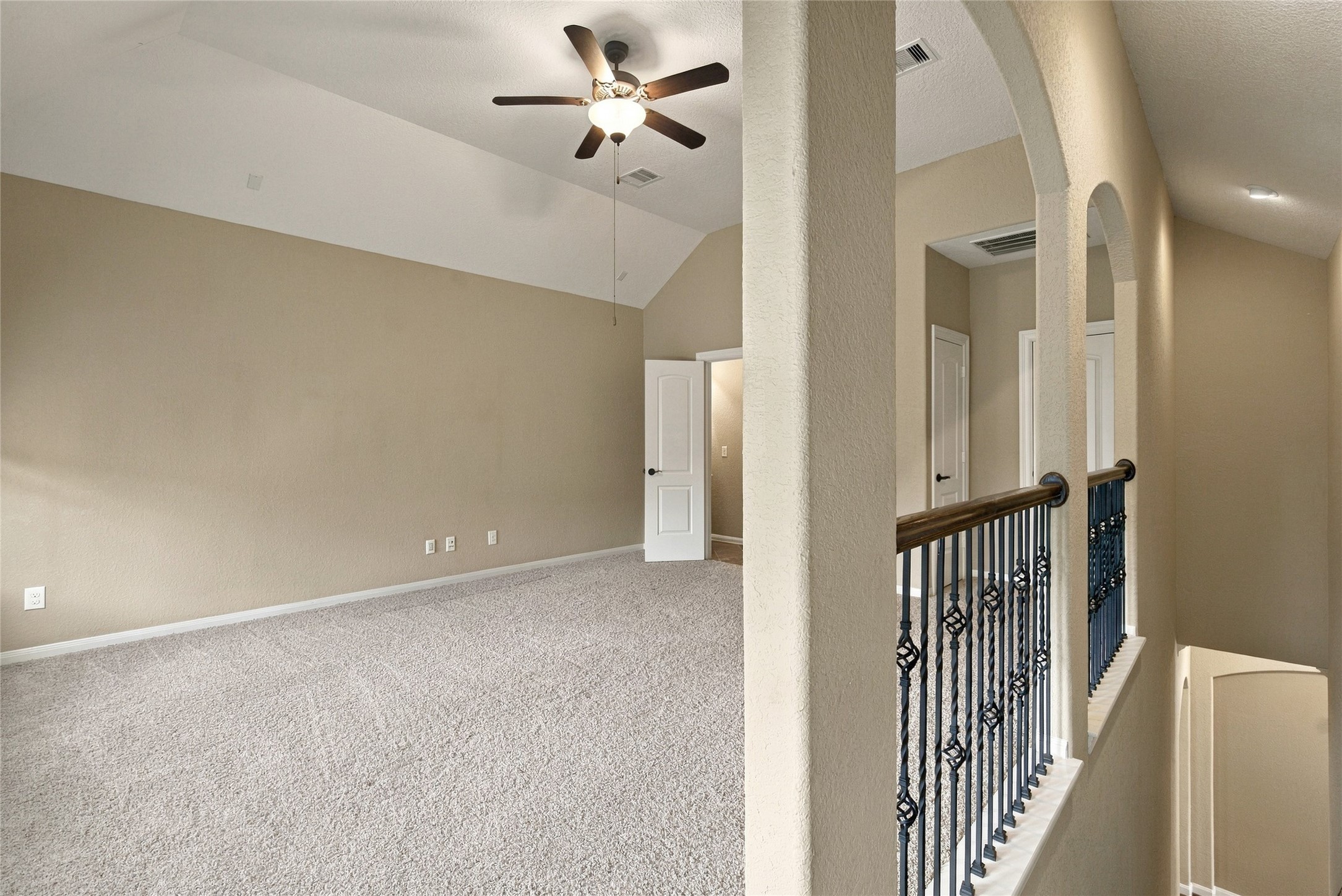 Versatile upstairs bonus room featuring plush carpeting, a ceiling fan, and an open layout. This spacious retreat is perfect for a game room or additional living space.