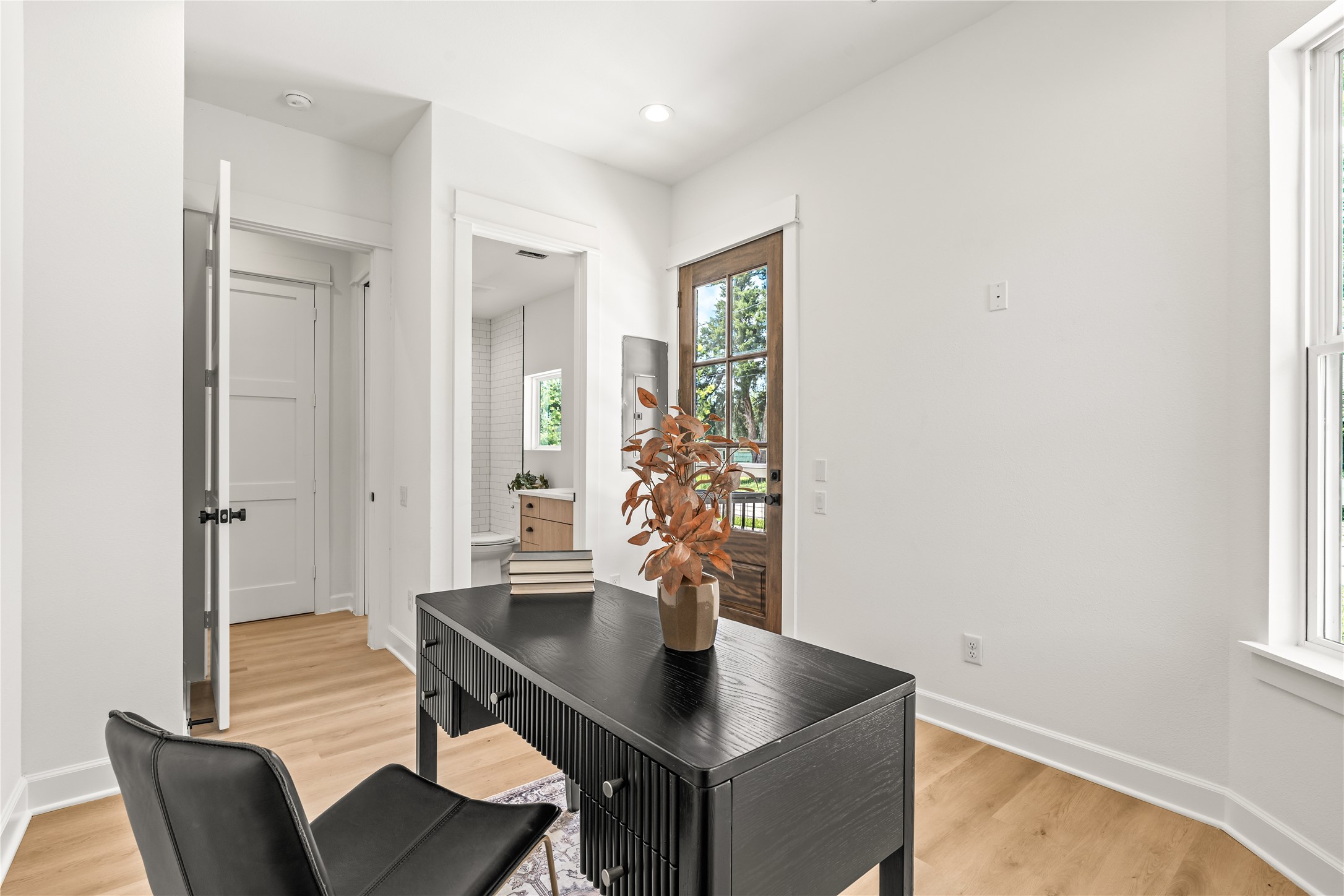 Alternate elevation  first-floor bedroom with glass back door and natural light throughout