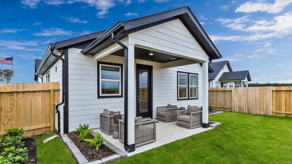 Rock lined landscaped beds add softness, color and vibrance to backyard.