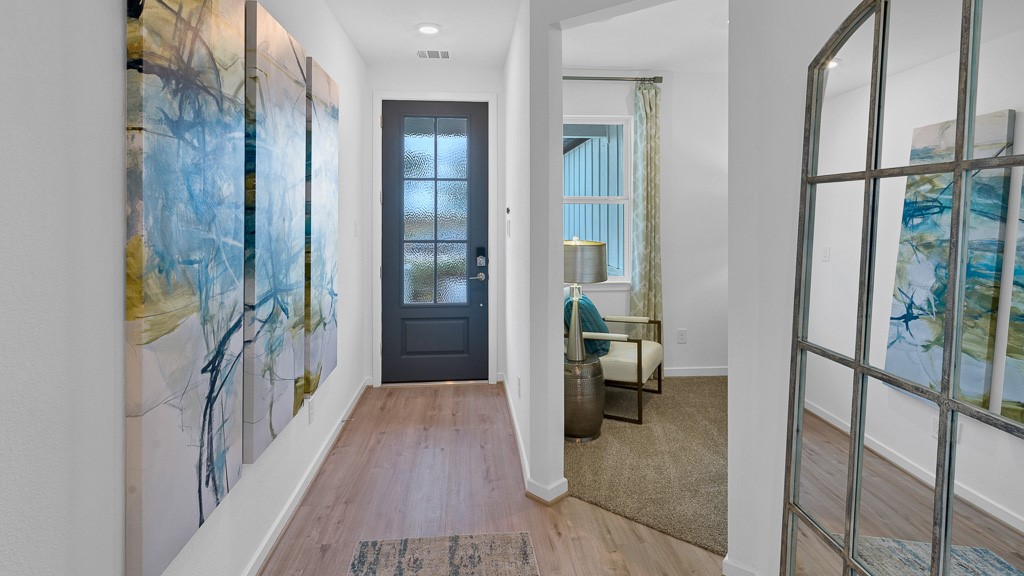 Foyer is light and bright with natural lighting from beautiful 6-lite glass custom front door.