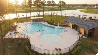 Gorgeous pool area next to lake.