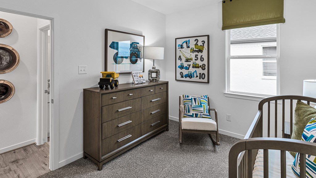 Bedroom 2 has designer white walls and premium warm gray carpeting.
