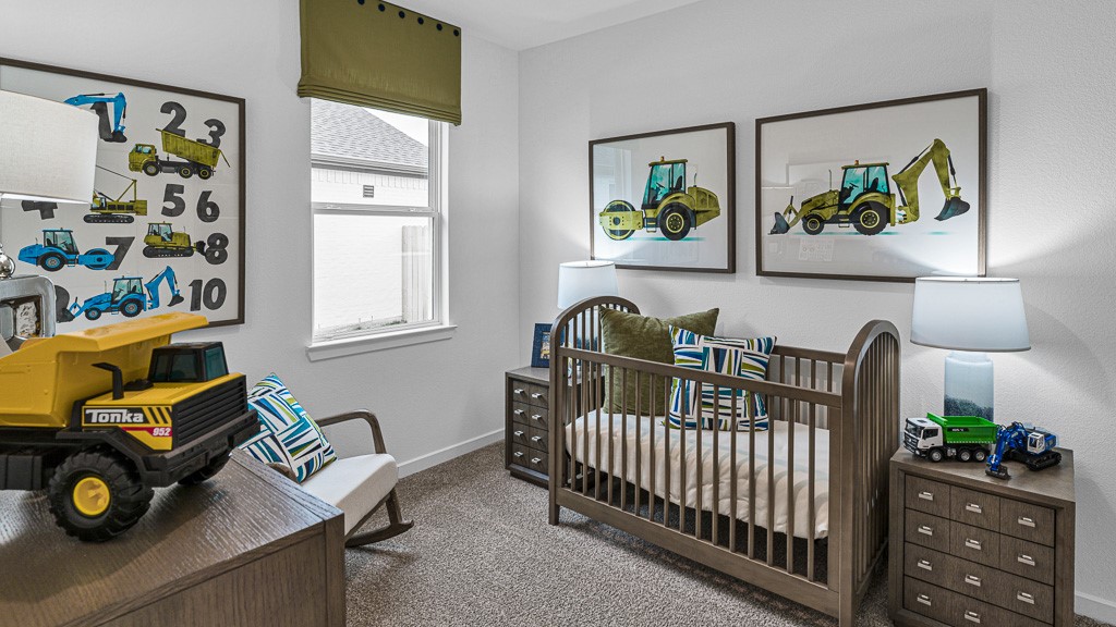 Bedroom 2 is welcoming and has a window topped with a custom valance, elongating the window and adding a high end style.