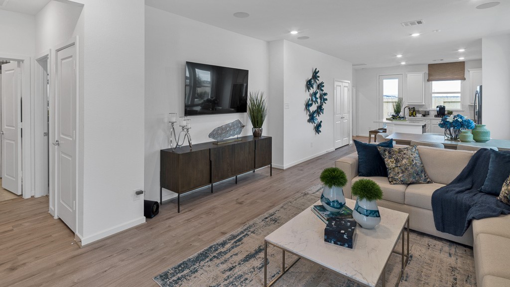 Well laid out split floor plan has secondary bedrooms and full bath off family room and primary suite in back of home.